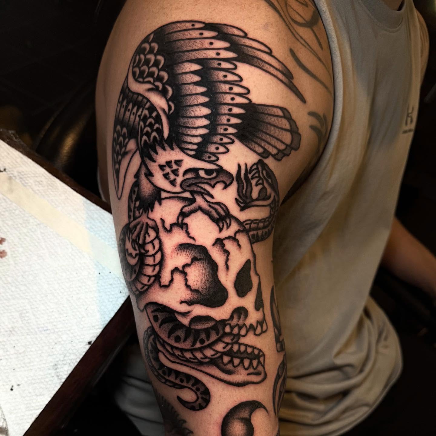 Eagle and skull American traditional tattoo on the forearm by Julia Louise