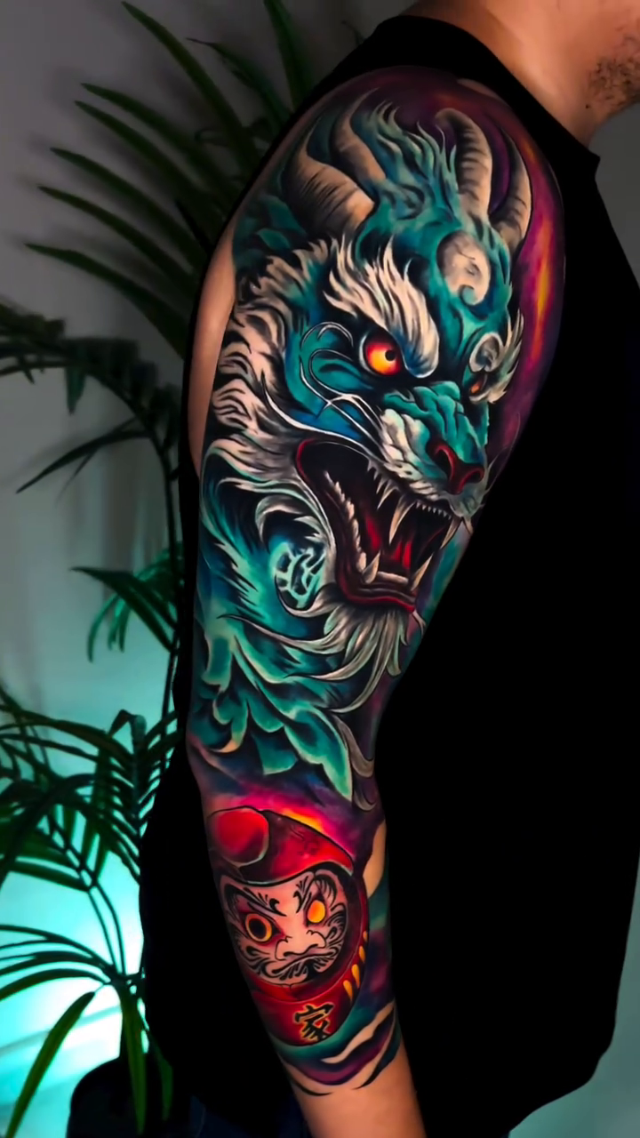 Dragon and Daruma doll sleeve Japanese tattoo on the upper arm by Kaly, Manhattan, NYC
