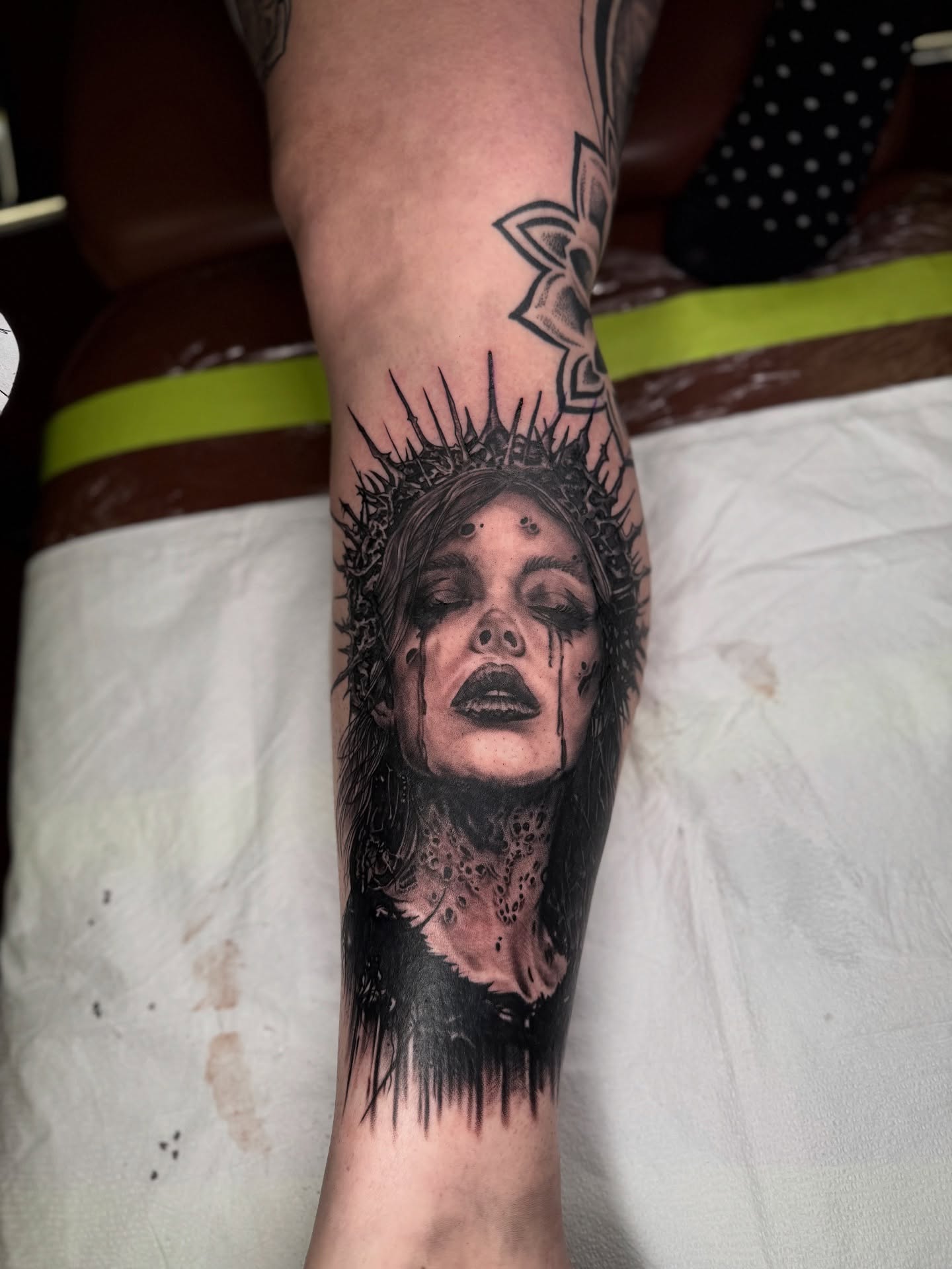 Woman with crown of thorns dark realism tattoo on the forearm by James Reed Tattoo artist