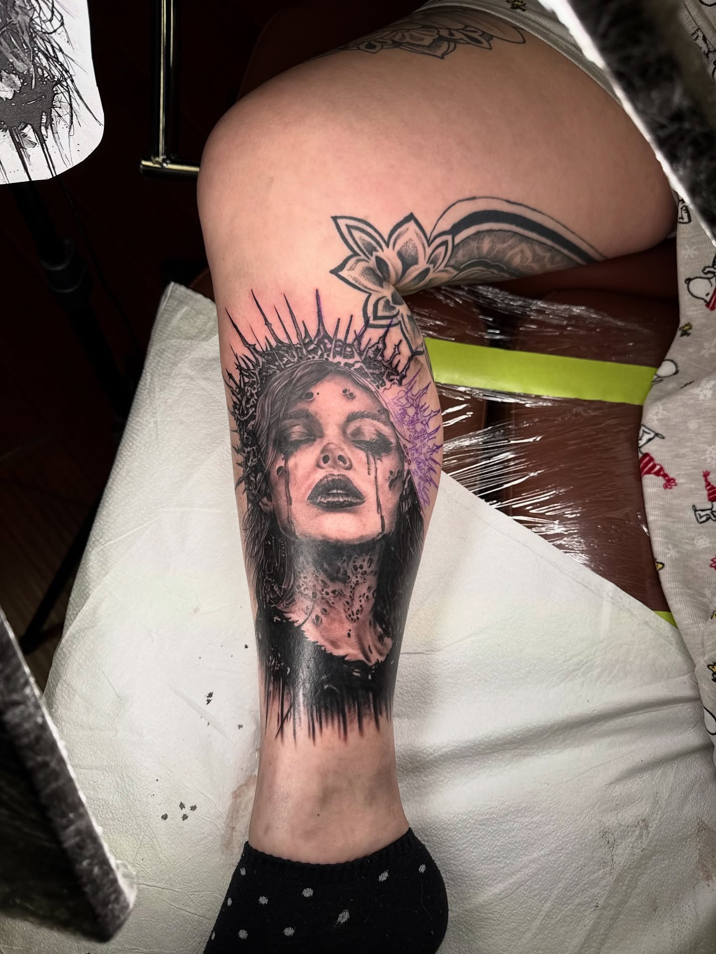 Woman with crown of thorns realism tattoo on the thigh by James Reed Tattoo artist