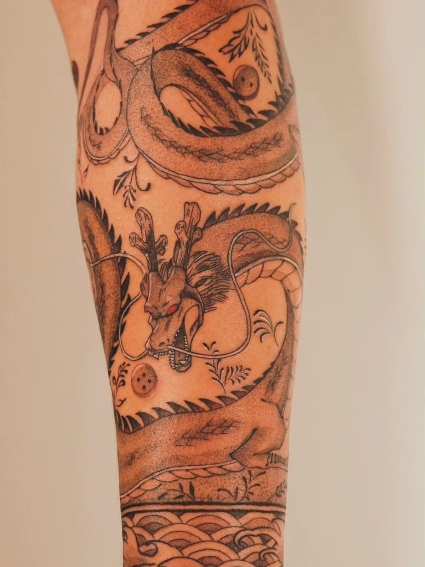 Dragon black and grey tattoo on the forearm by Johnathan Nguyen
