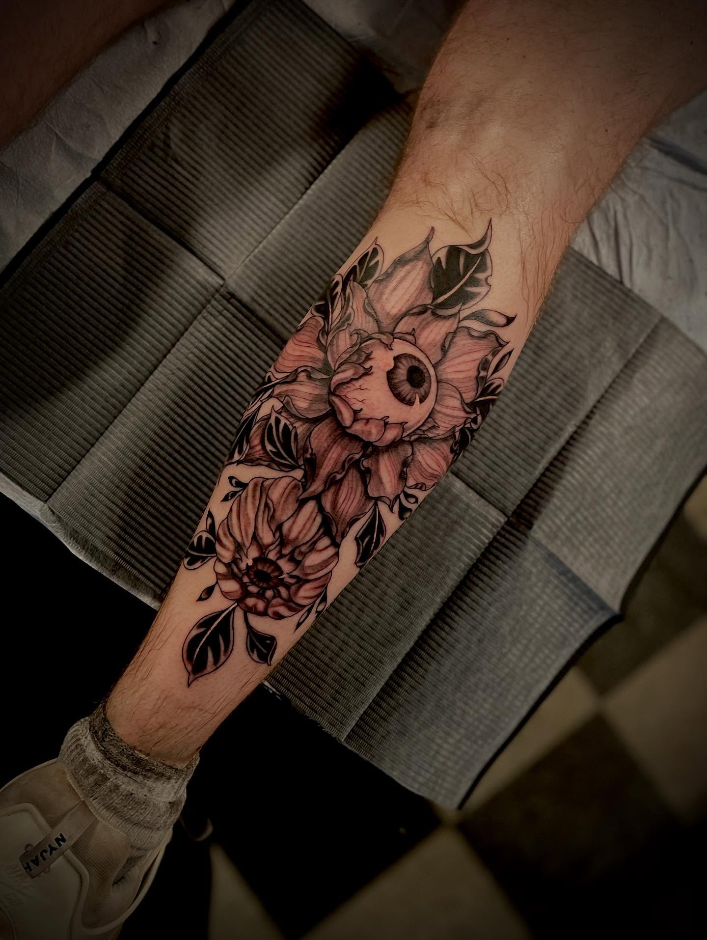 Flower with skull black and grey tattoo on the forearm by Jacob Finelli