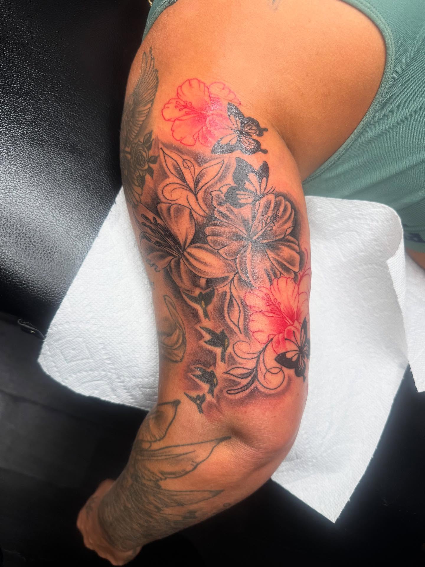 Floral arrangement black and grey tattoo on the forearm by Tattoosbydevon