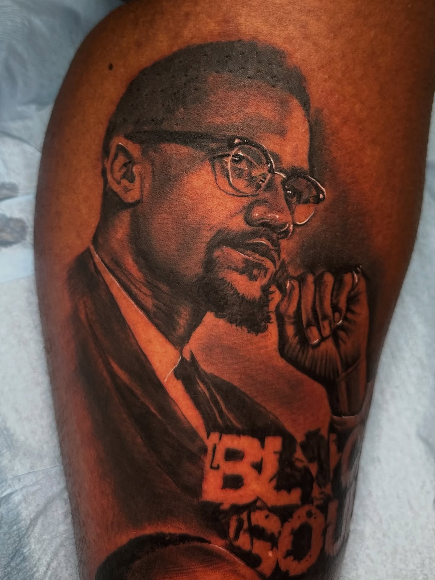 Malcolm X realism tattoo on the thigh by guinn_art_tatts, Le Moule