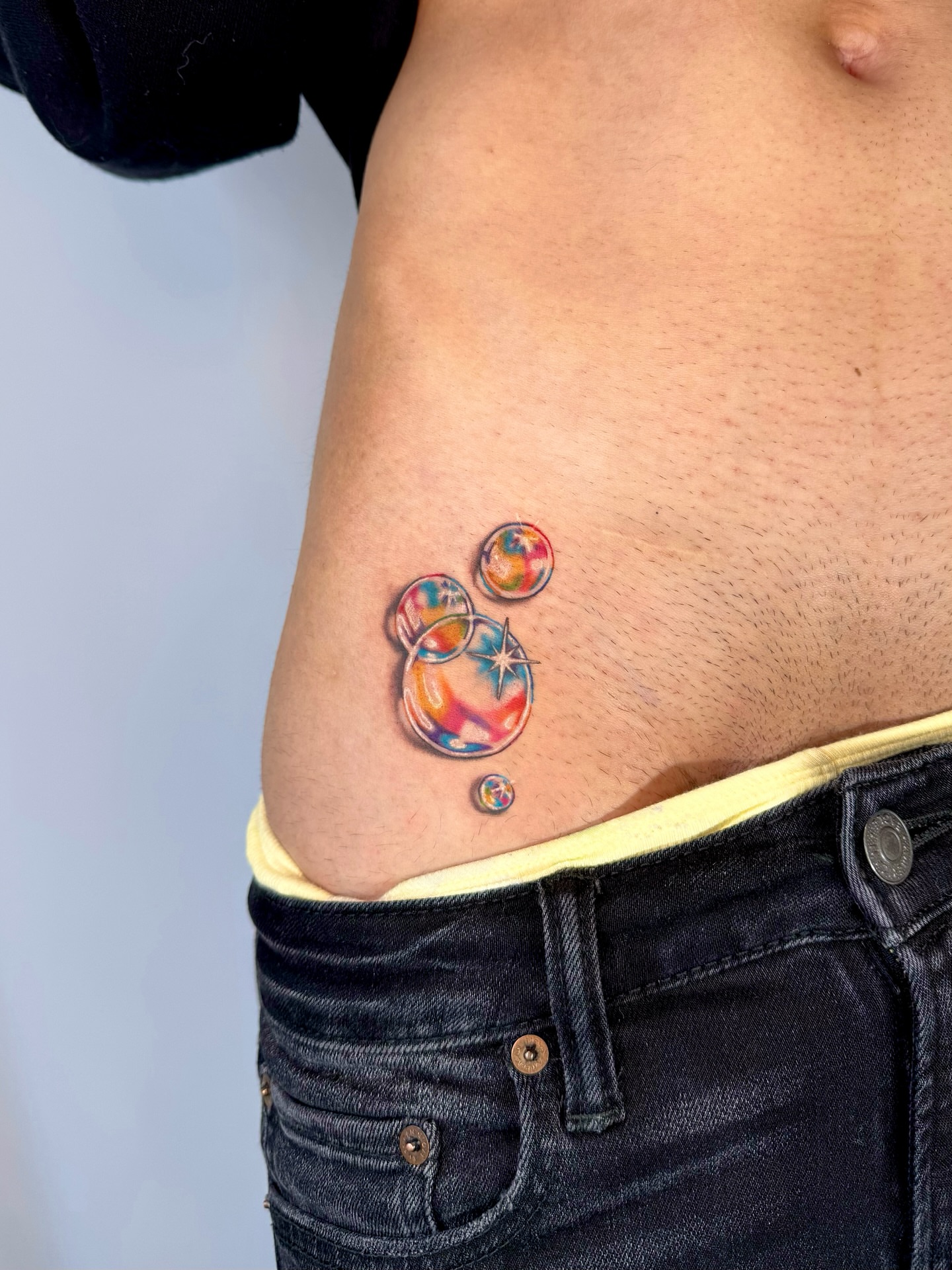 Abstract bubbles dotwork tattoo on the ribs by Franky A Bonifacio, Seattle, Washington