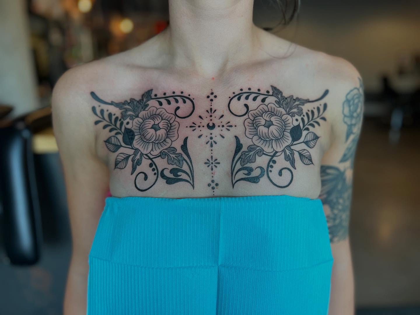 Floral design black and grey tattoo on the chest by Siërra Nicole, Minneapolis, Minnesota