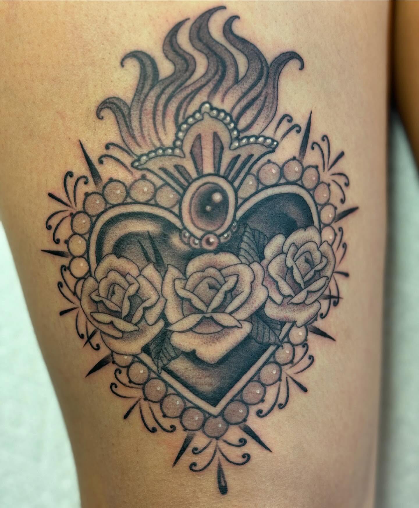 Heart with roses American traditional tattoo on the thigh by Storm