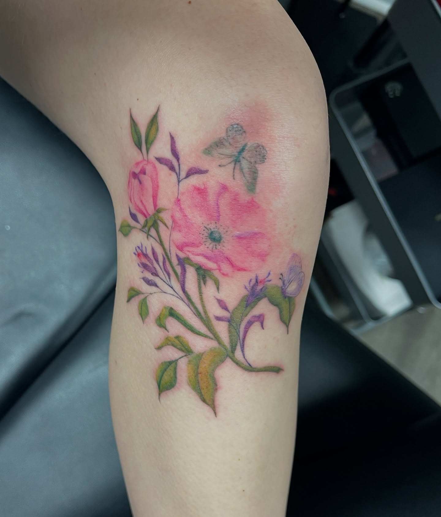 Floral bouquet watercolor tattoo on the thigh by Cortnie, Nashville, Tennessee