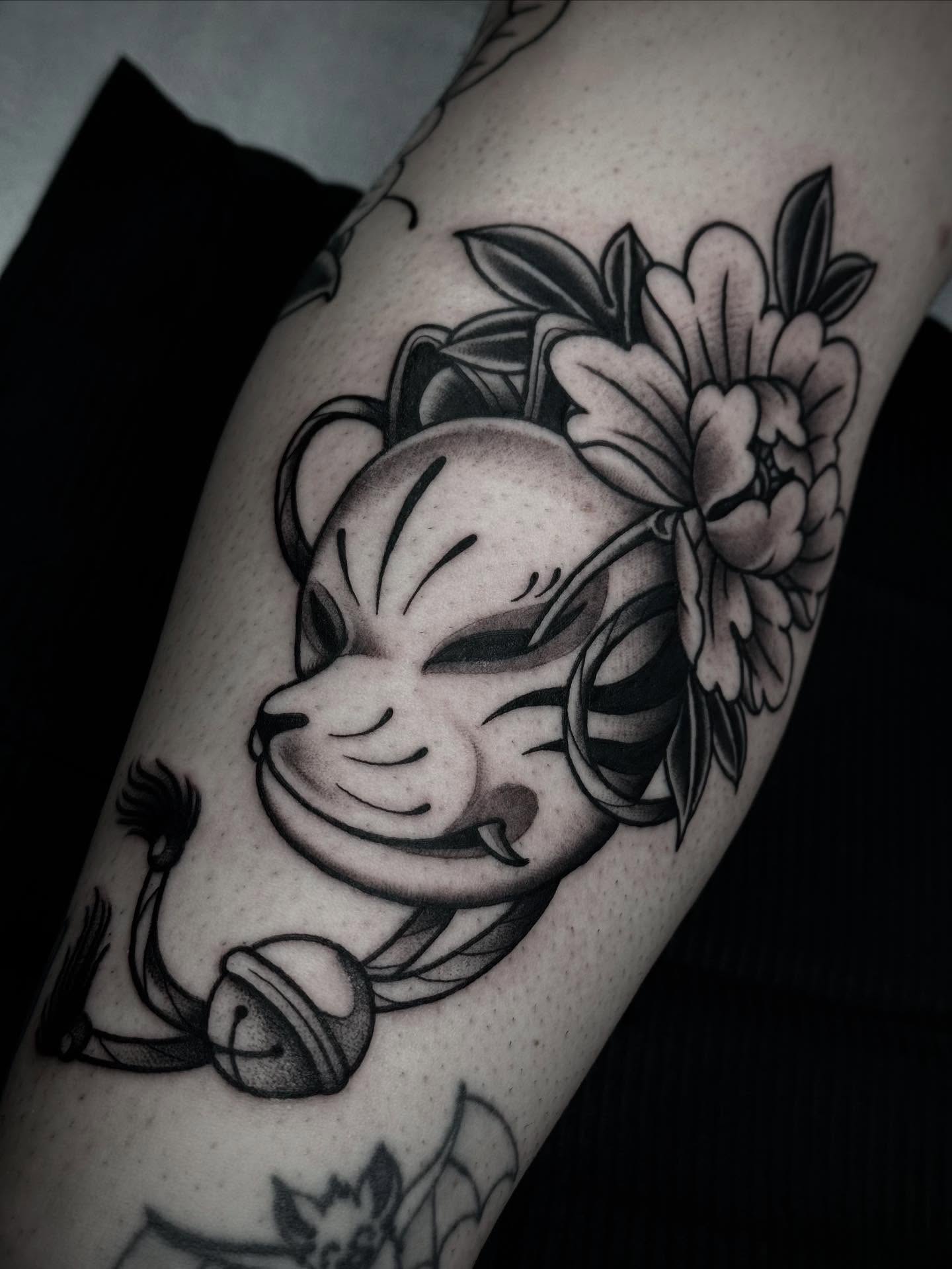Cat with flowers black and grey tattoo on the forearm by Ally noel