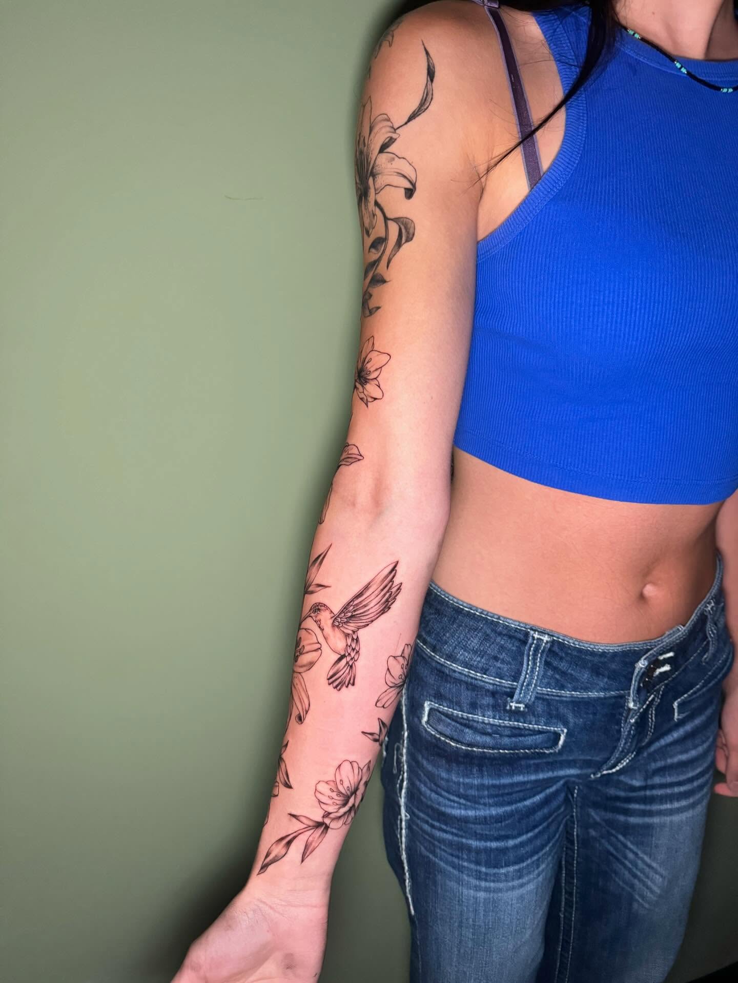 Bird and flowers American traditional tattoo on the forearm by Kenzie🖤