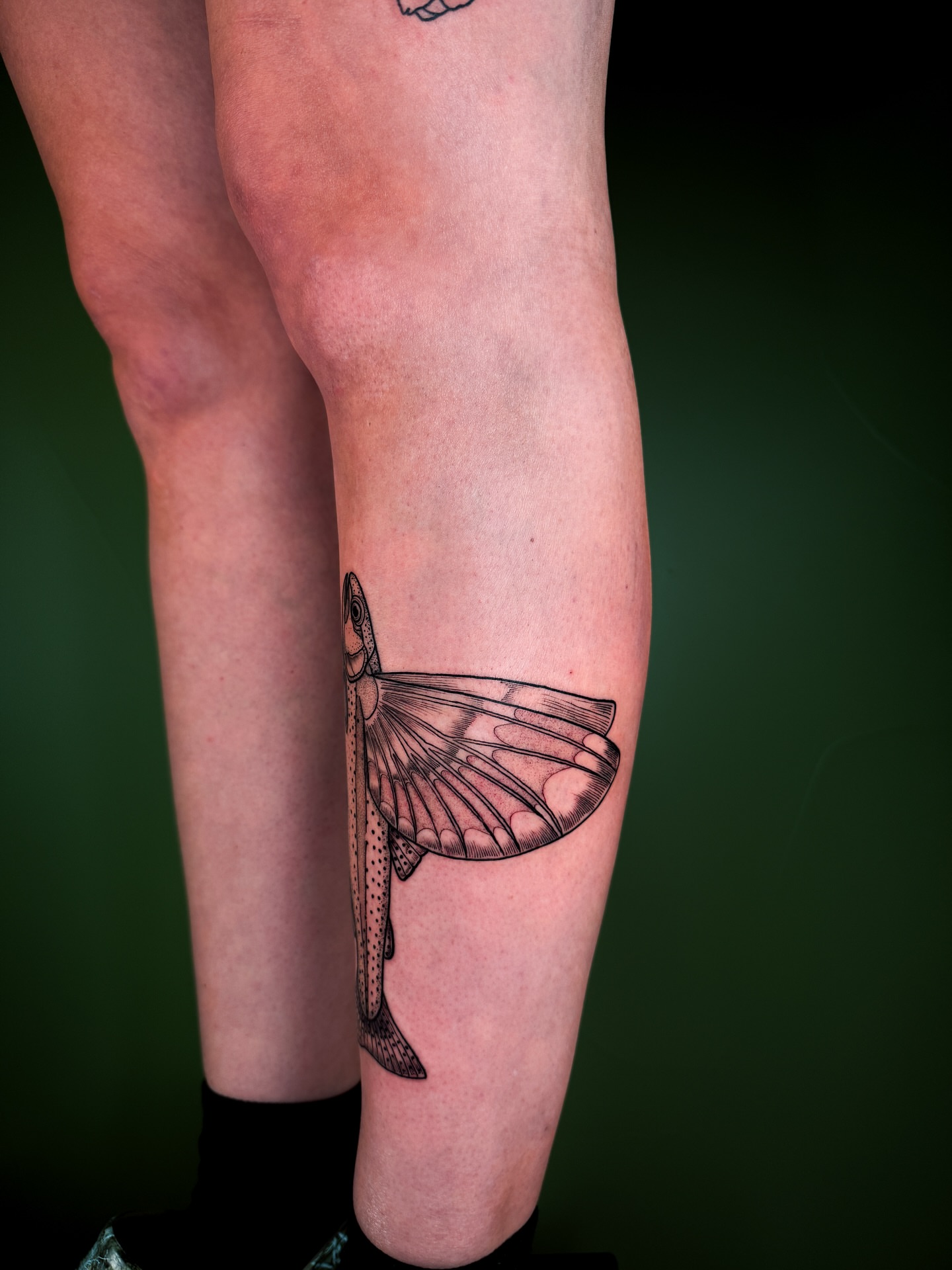 Fish black and grey tattoo on the leg by Zella Mäkelä