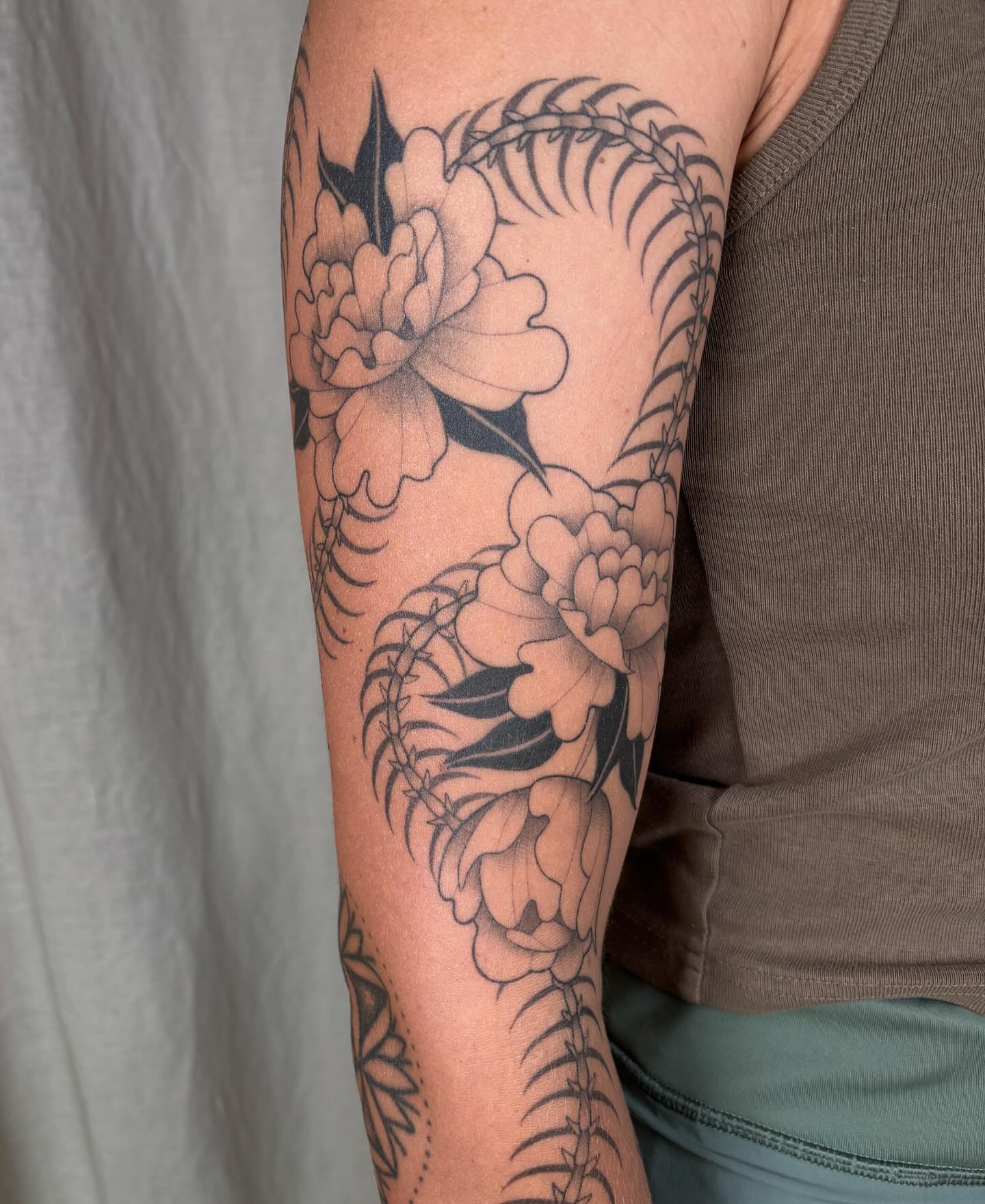 Peony flowers black and grey tattoo on the forearm by Anna Sage