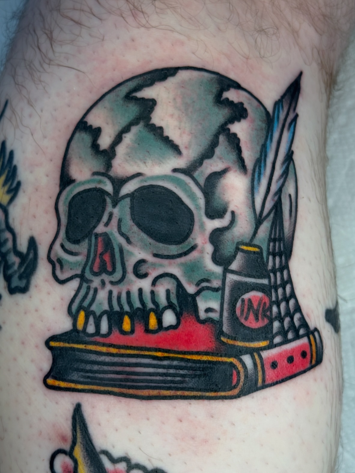 Skull and book American traditional tattoo on the forearm by Tony Kaplan