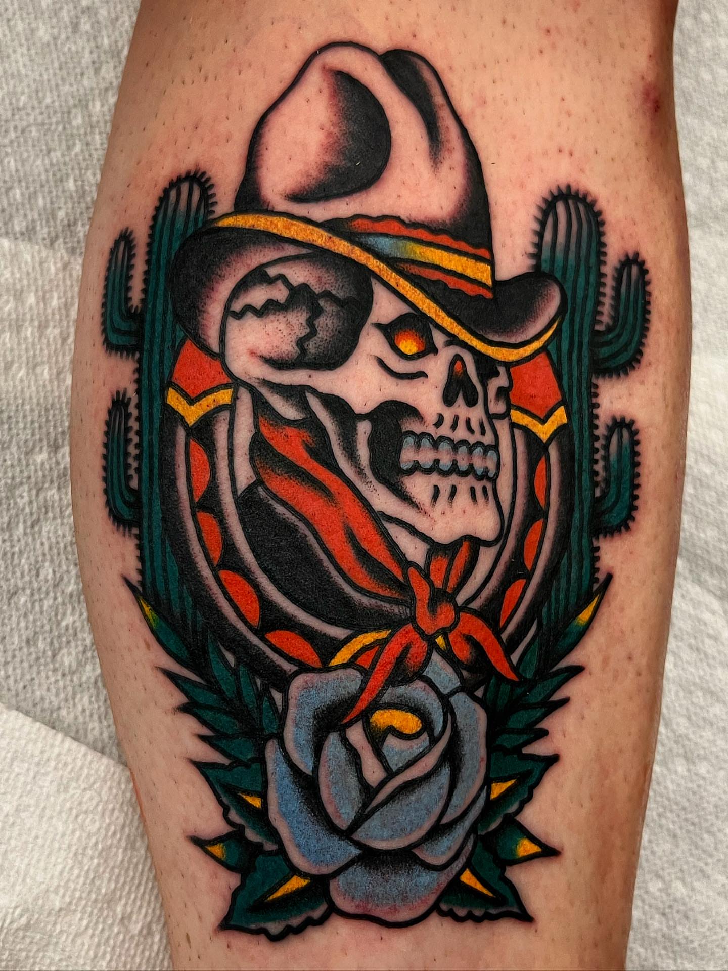 Cowboy skull with cactus American traditional tattoo on the forearm by Jake LiCausi