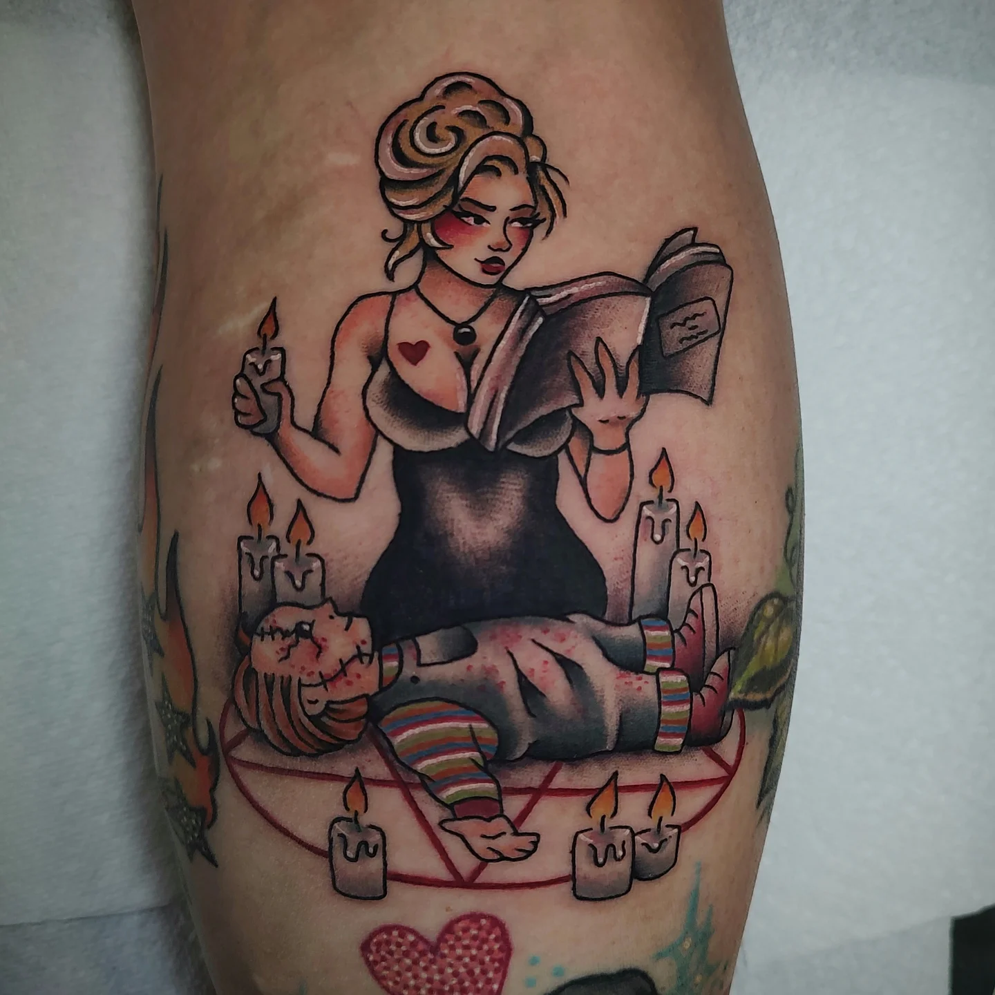 Woman reading American traditional tattoo on the thigh by Hope Higgins