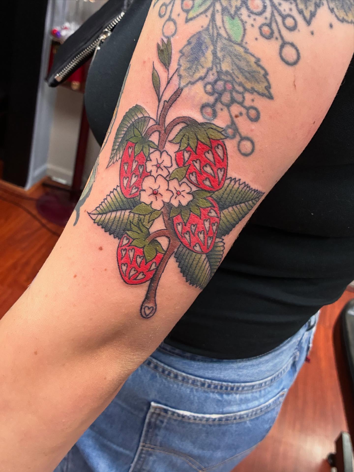 Strawberries and flowers American traditional tattoo on the forearm by Kat π