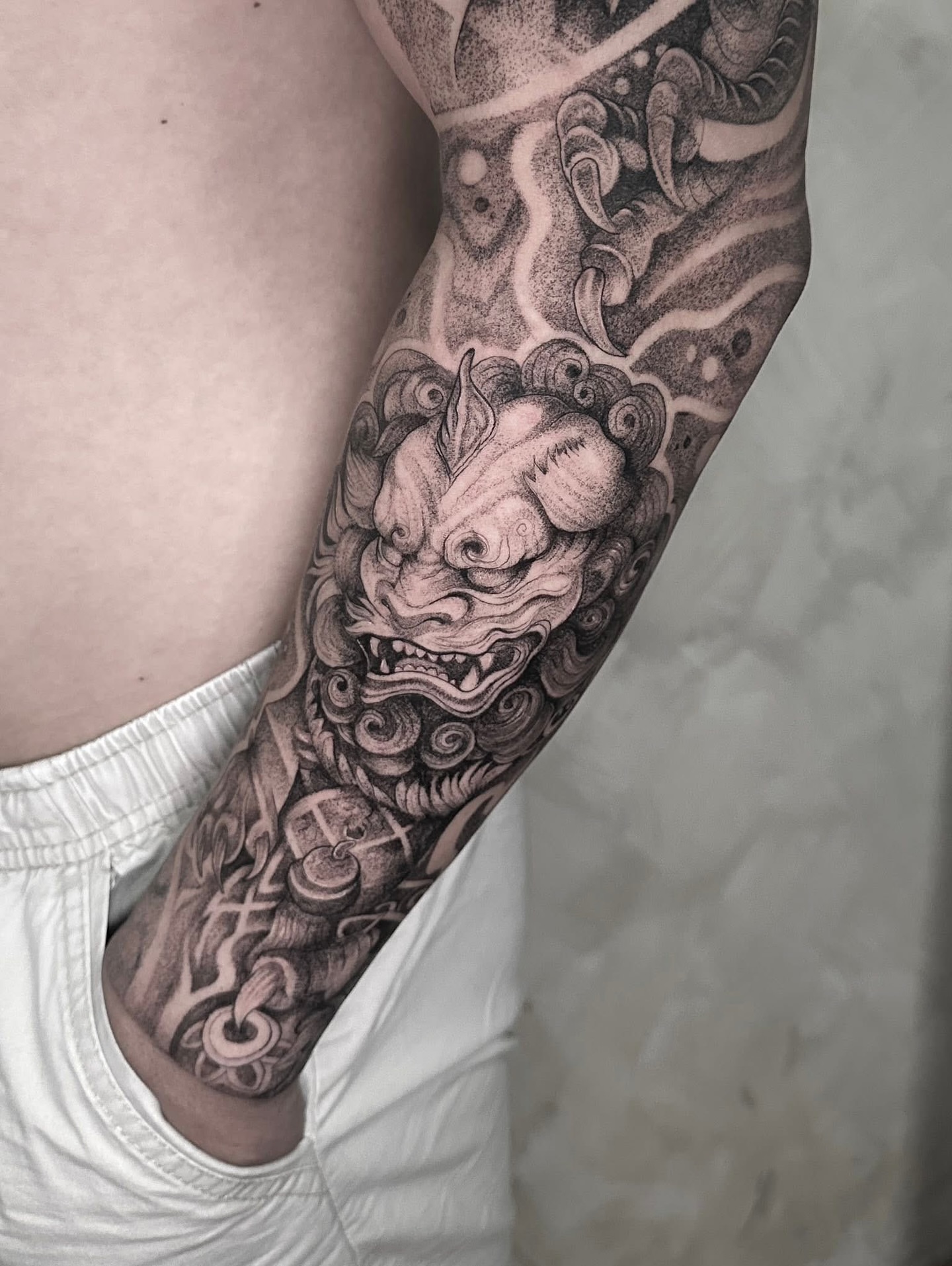 Lion mask dotwork tattoo on the forearm by Arhem Quiambao