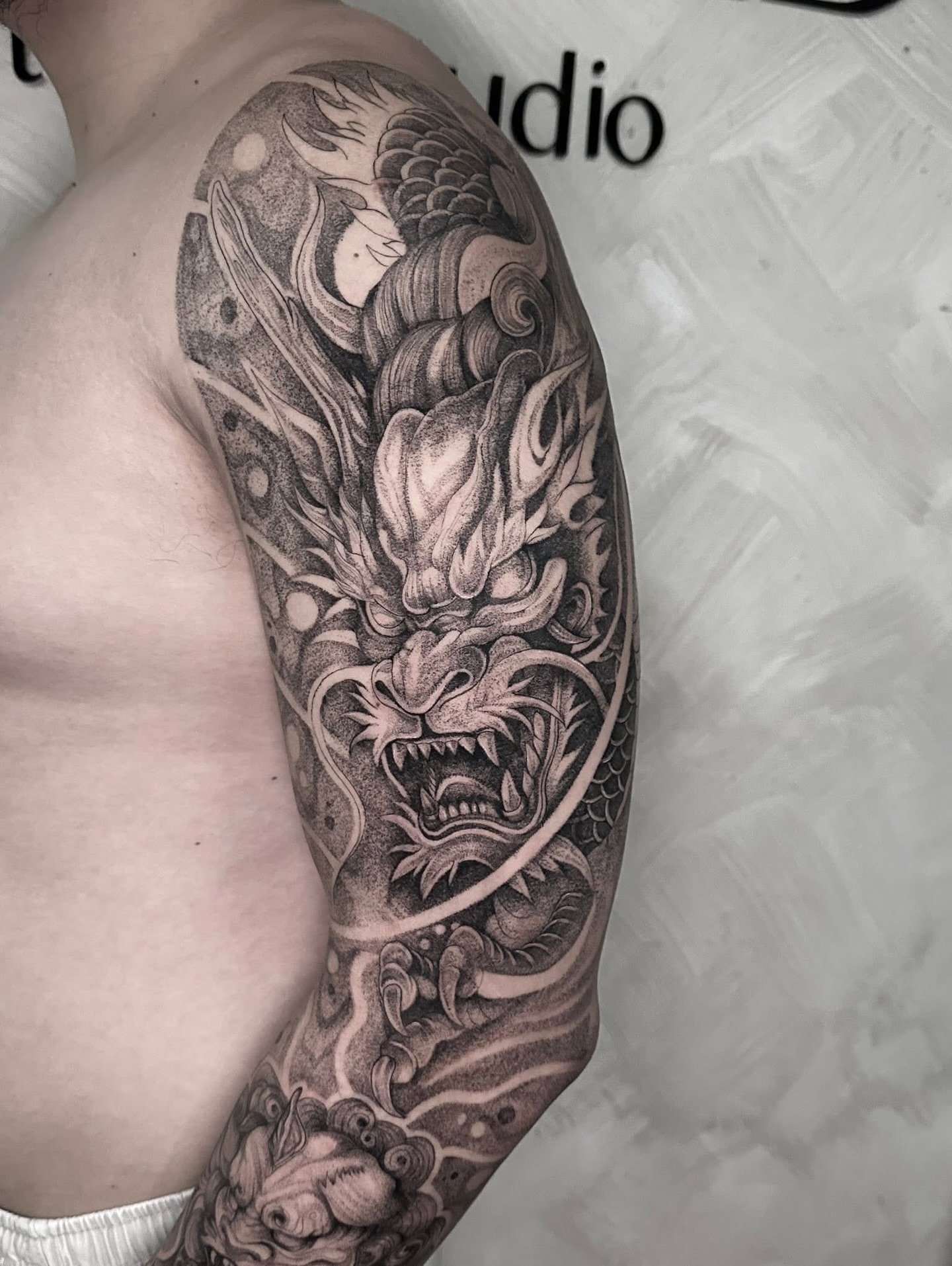 Dragon dotwork tattoo on the upper arm by Arhem Quiambao