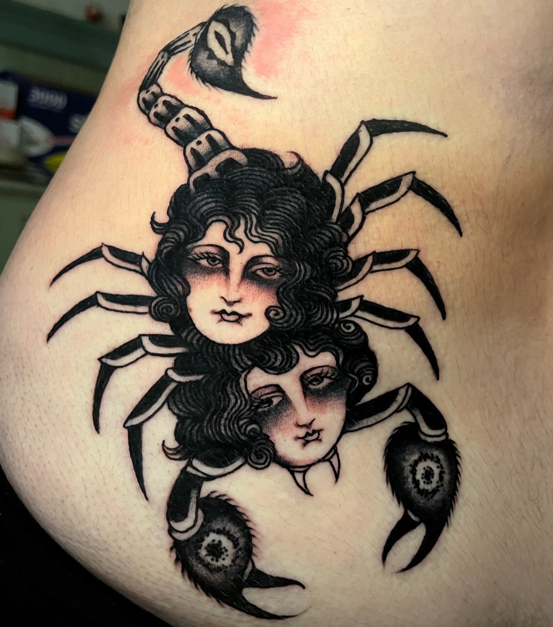 Scorpion and faces American traditional tattoo on the thigh by JohnJohn