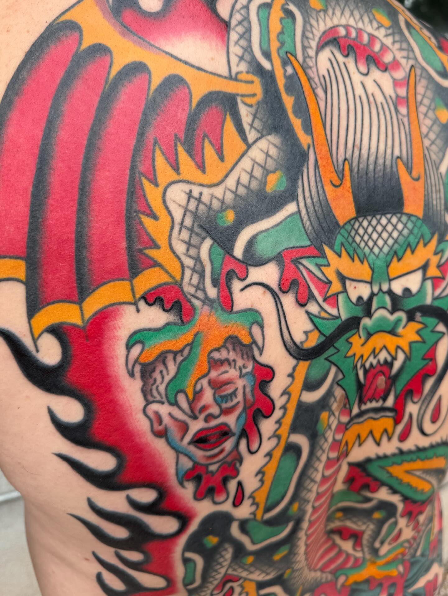 Dragon and clown American traditional tattoo on the back by James Shepherd, Austin, Texas