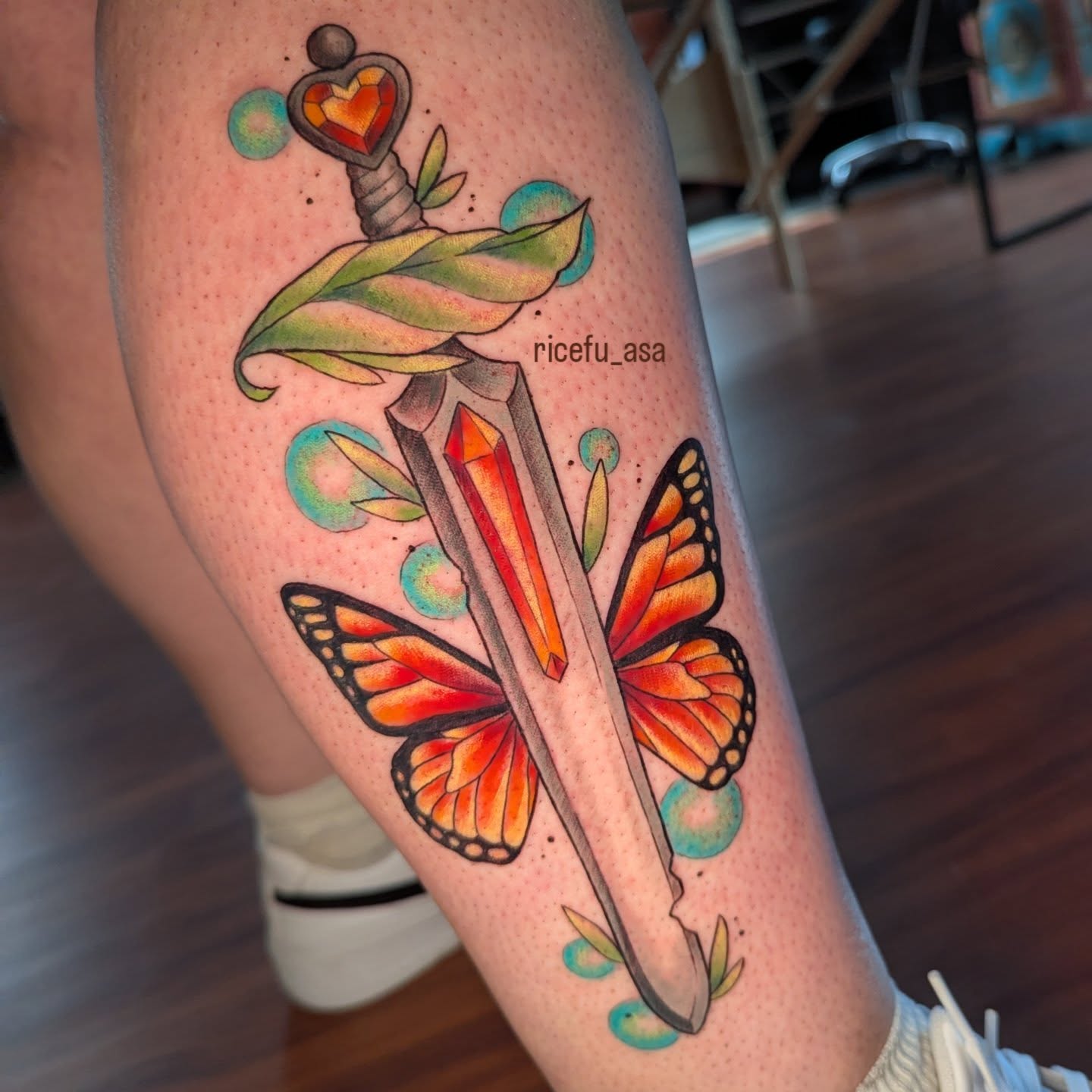 Butterfly and sword American traditional tattoo on the forearm by Ricefu Art & Tattoo