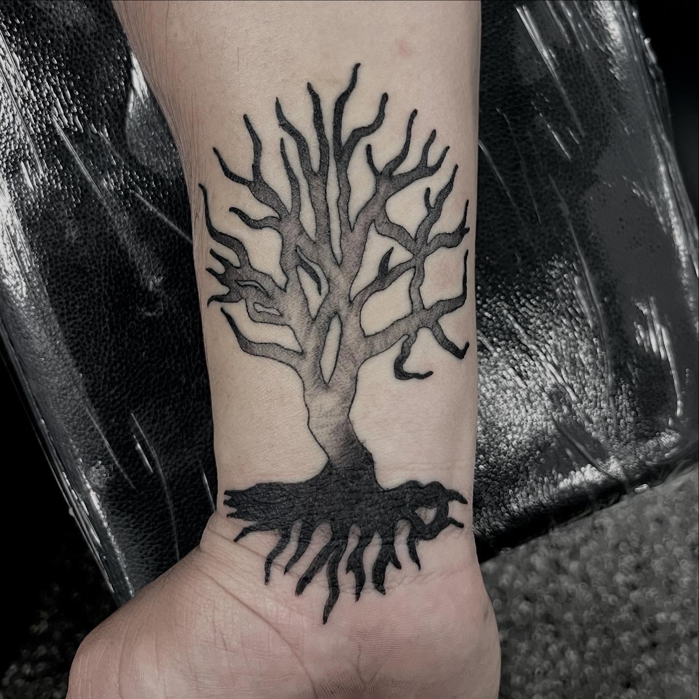 Tree black and grey tattoo on the forearm by Angel Arceo