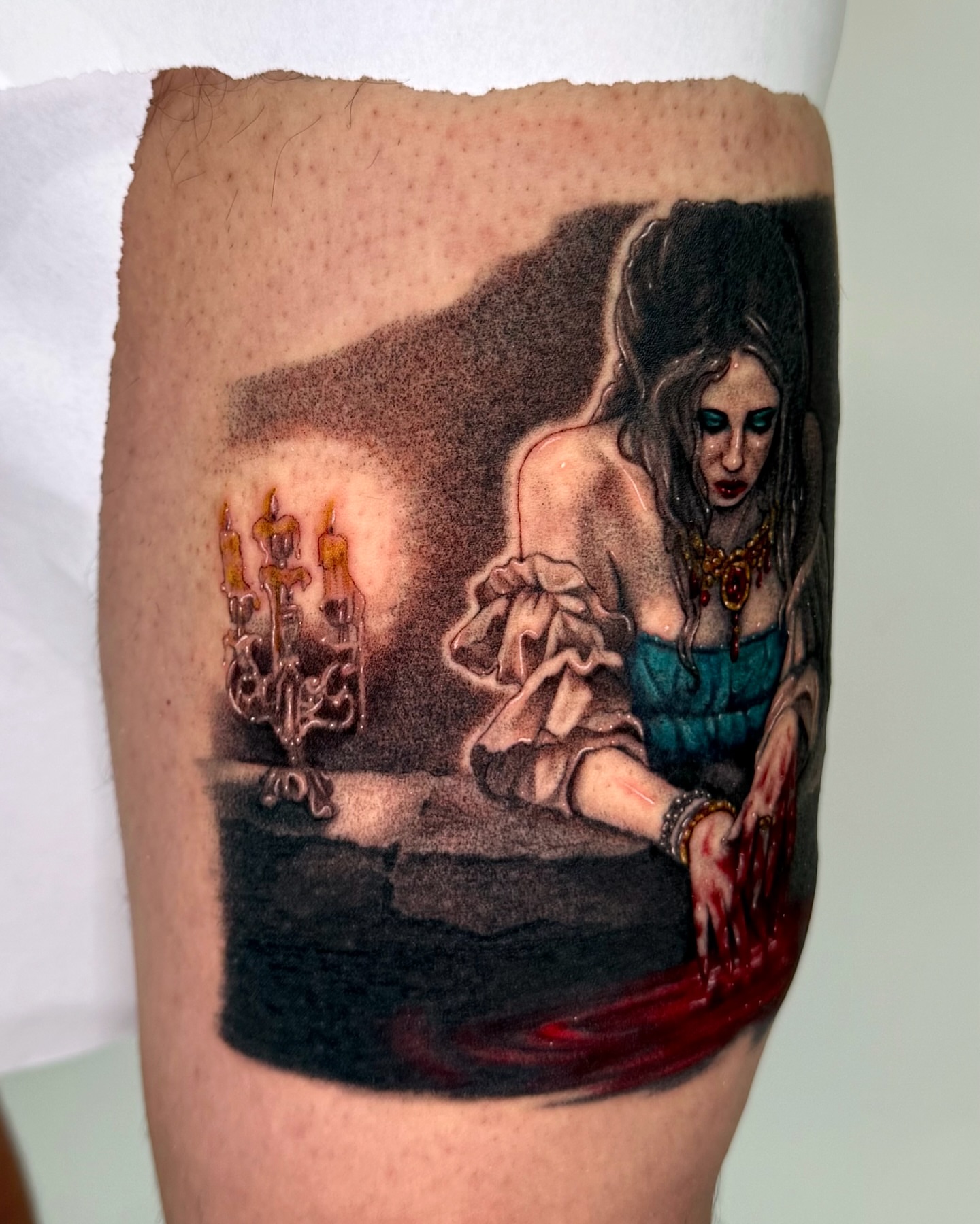 Woman with blood dark realism tattoo on the thigh by Mystikal Blue Casares