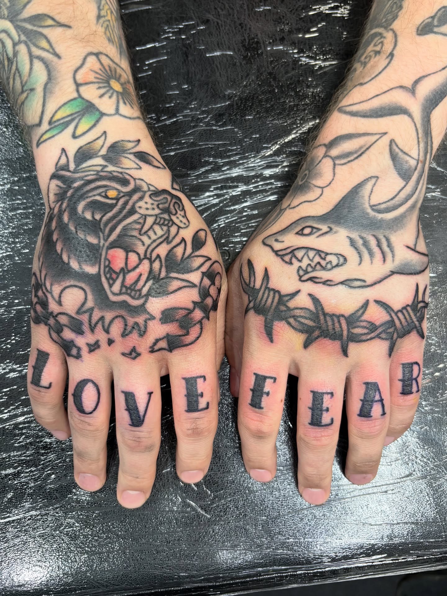 Tiger and shark American traditional tattoo on the hand by Jamie Yuu, Minneapolis, Minnesota