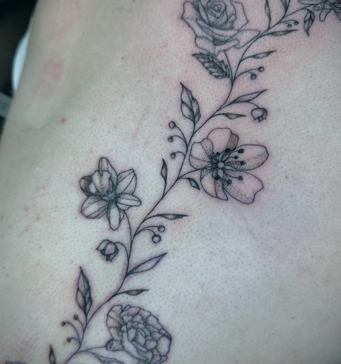 Floral vine black and grey tattoo on the shoulder by Bell