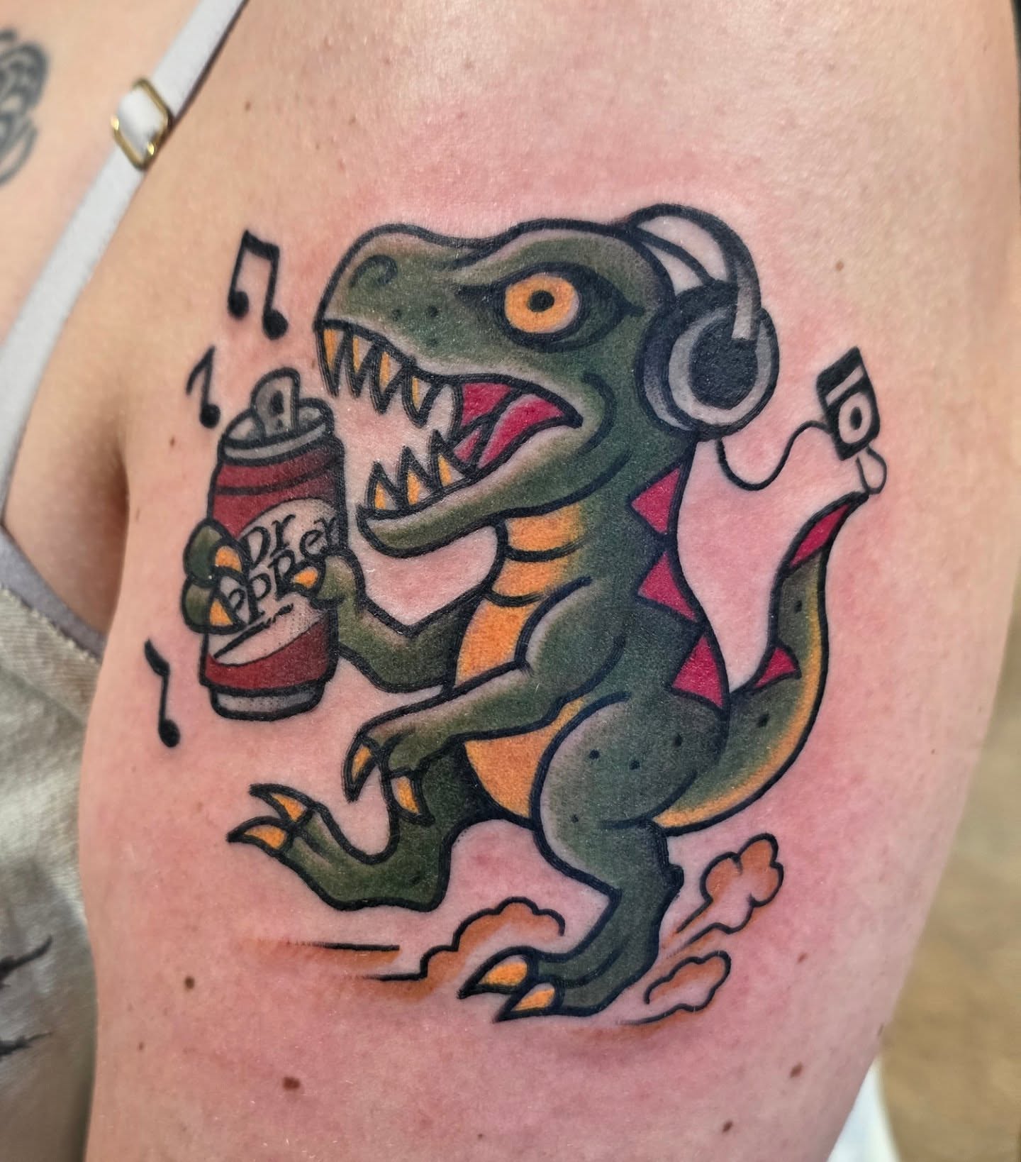 Dinosaur drinking soda American traditional tattoo on the thigh by BZ Artistry