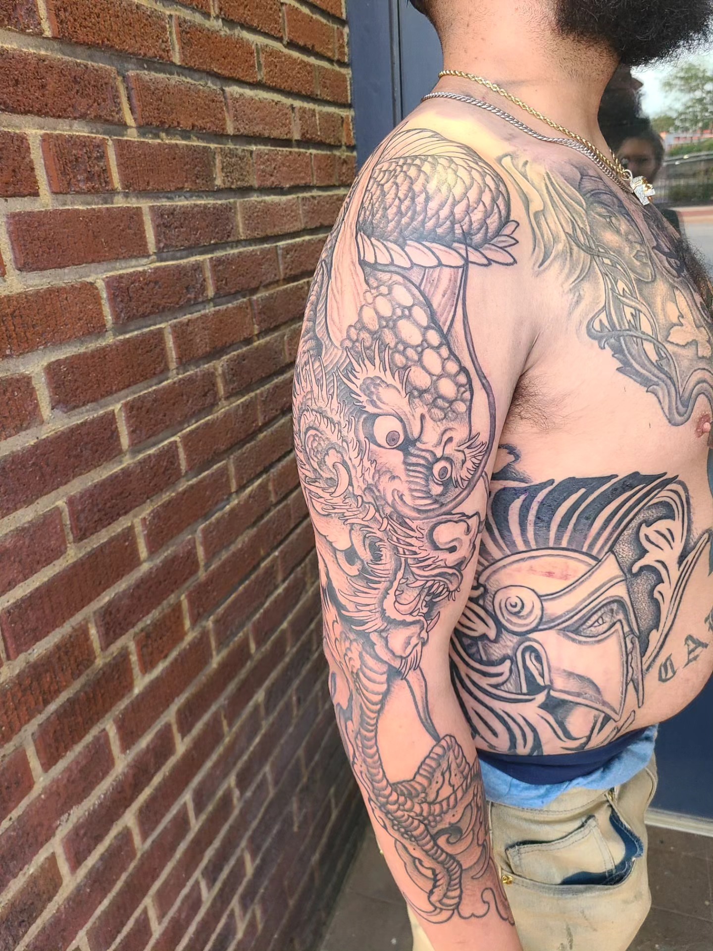 Dragon and mask japanese irezumi tattoo on the shoulder by David Vodicka