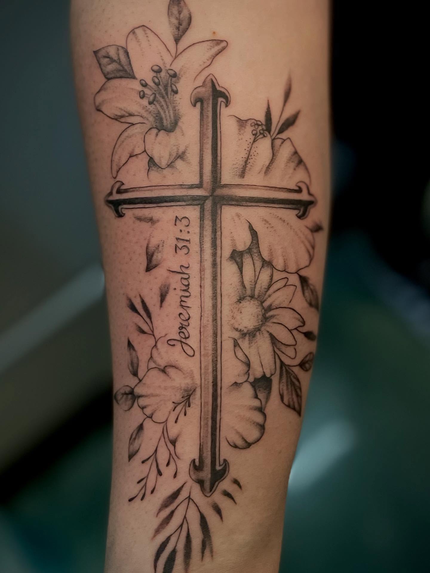 Cross with floral elements realism tattoo on the forearm by Bryce Presley, Mission, Kansas