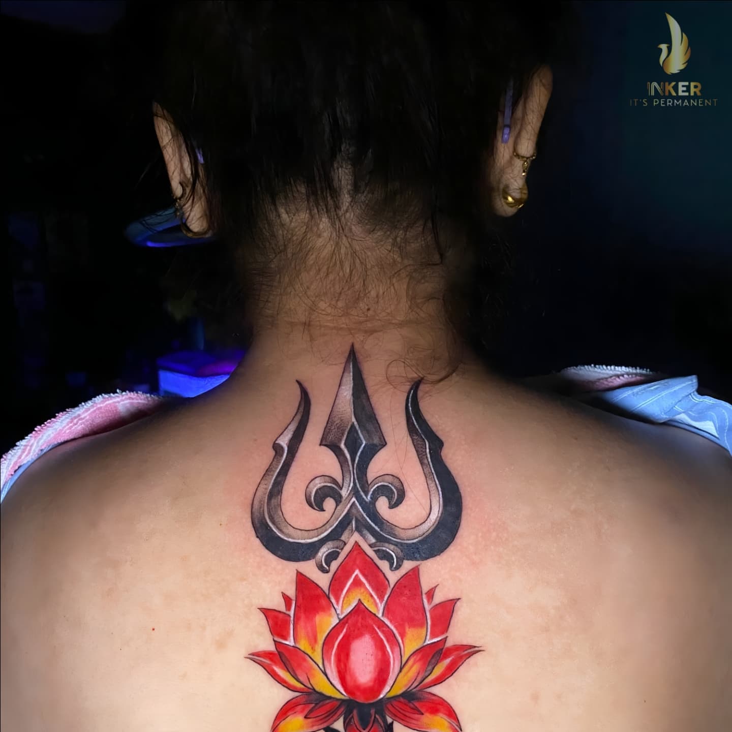 Lotus flower and trident geometric tattoo on the back by Shubhadeep Mukherjee