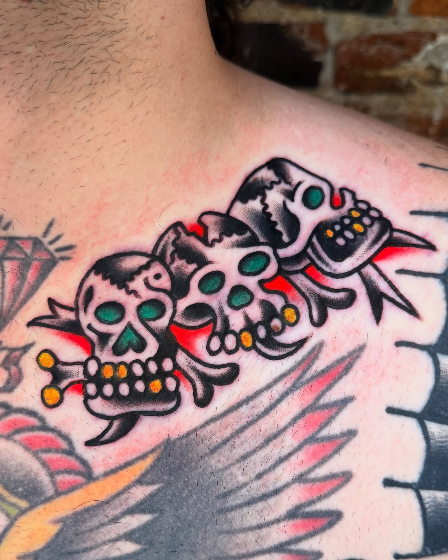 Skulls and crossbones American traditional tattoo on the shoulder by Cullen Bleser Quinn