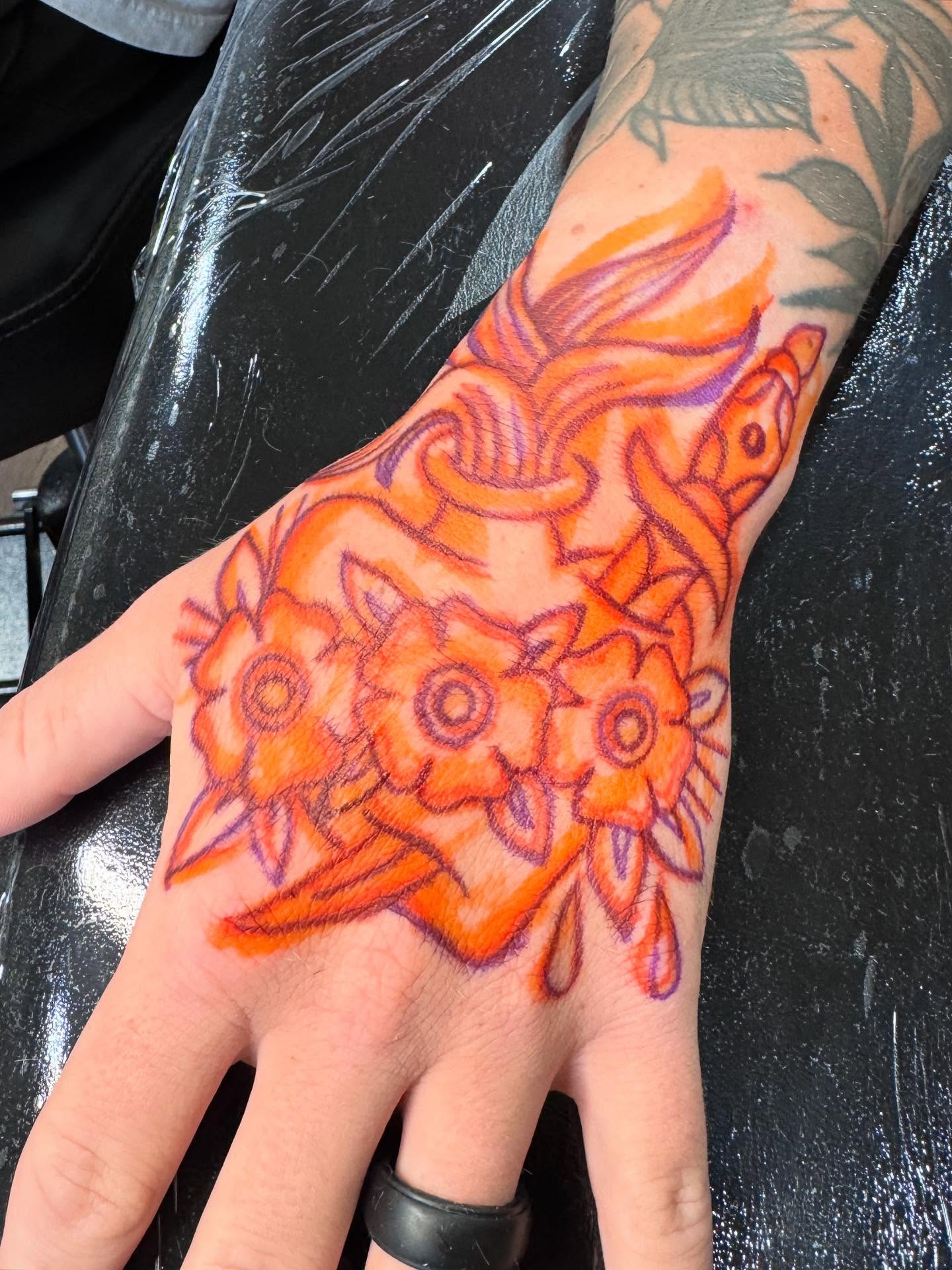 Sunflowers new school tattoo on the hand by Ryan Engels