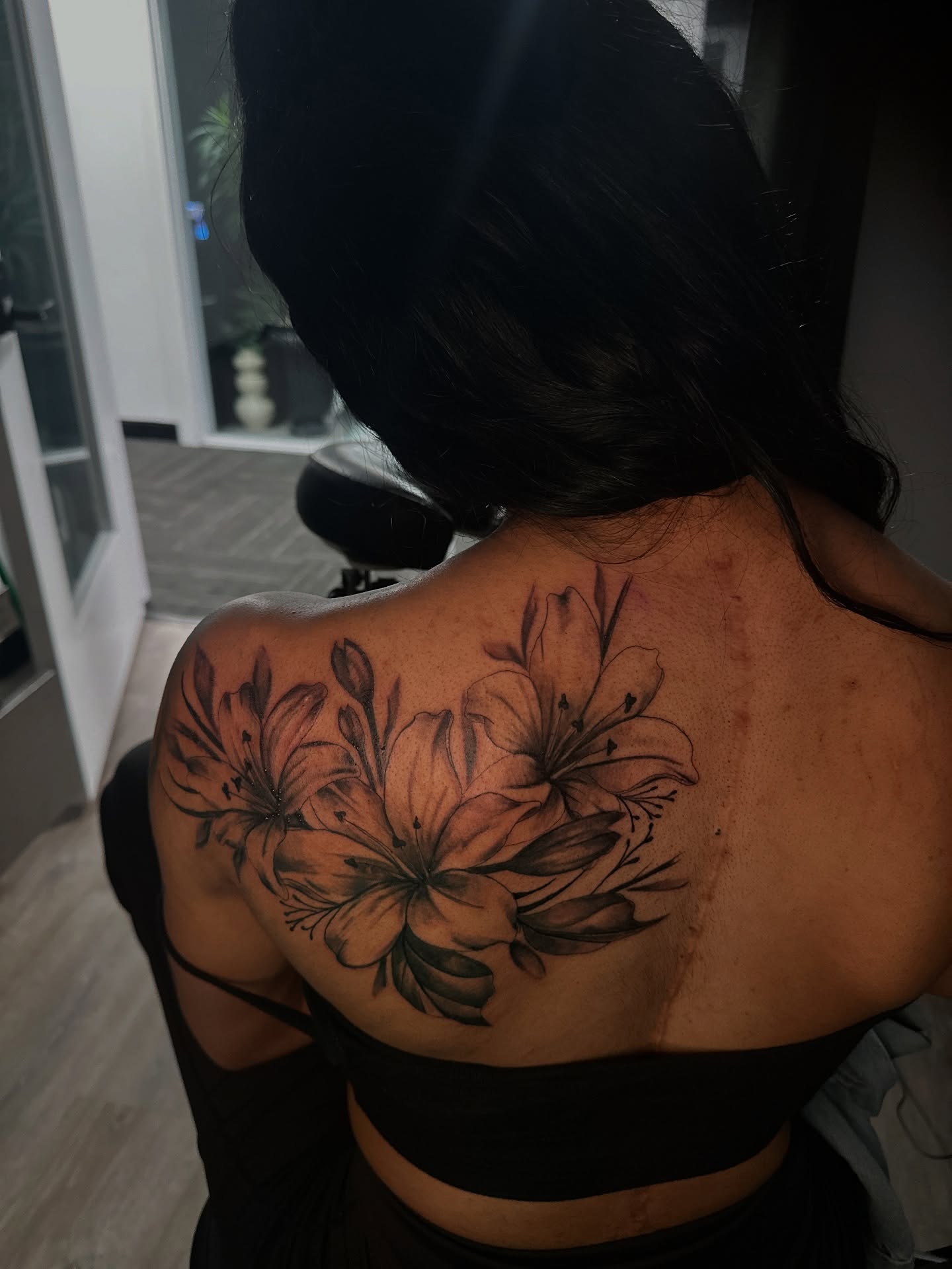 Lilies black and grey tattoo on the back by ᴡᴏʀᴍ
