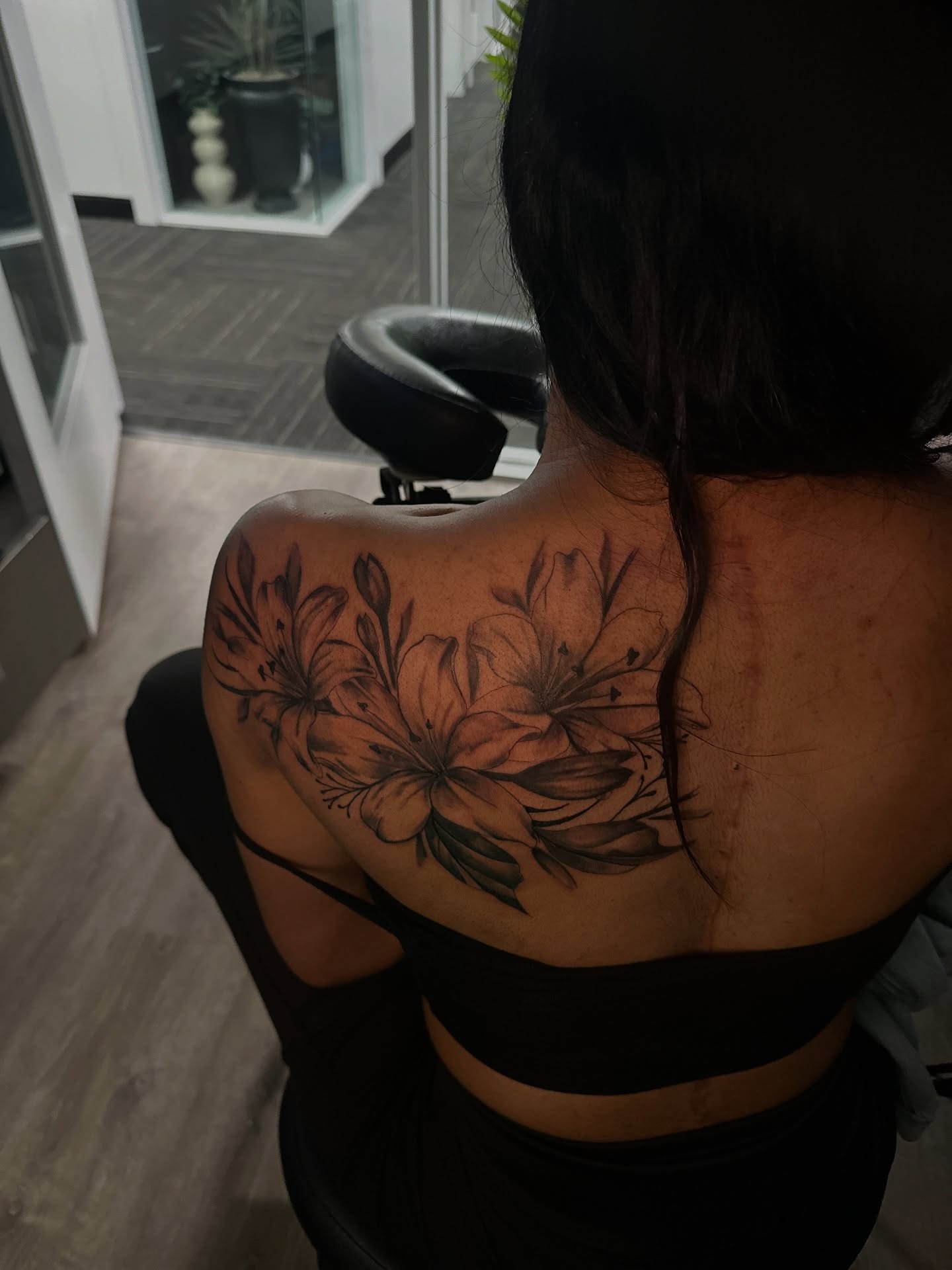 Lilies black and grey tattoo on the shoulder by ᴡᴏʀᴍ