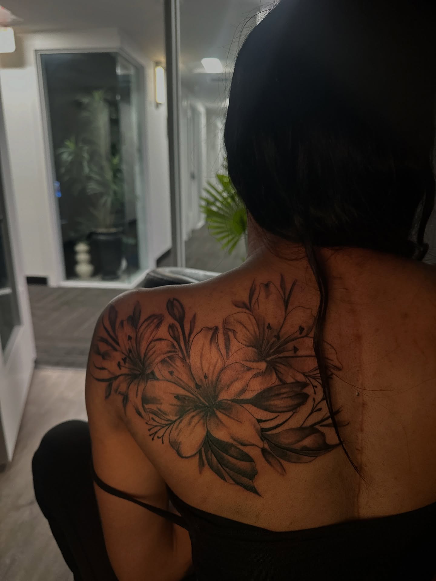 Lilies black and grey tattoo on the shoulder by ᴡᴏʀᴍ