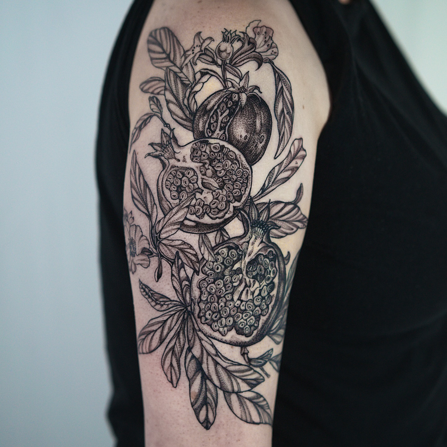 Pomegranates black and grey tattoo on the upper arm by H I R A  L U P E - tattoo artist, Oakland, California