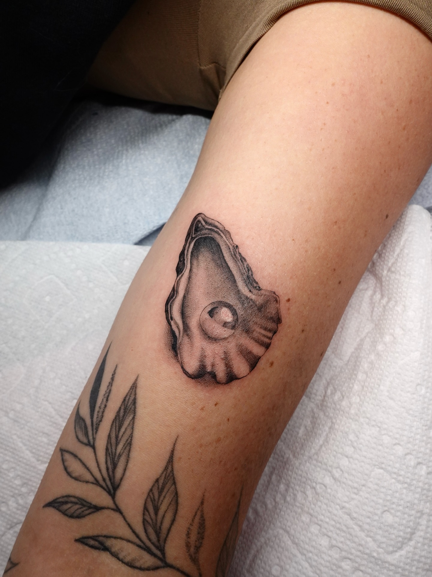 Oyster shell realism tattoo on the forearm by Tat by Brendan