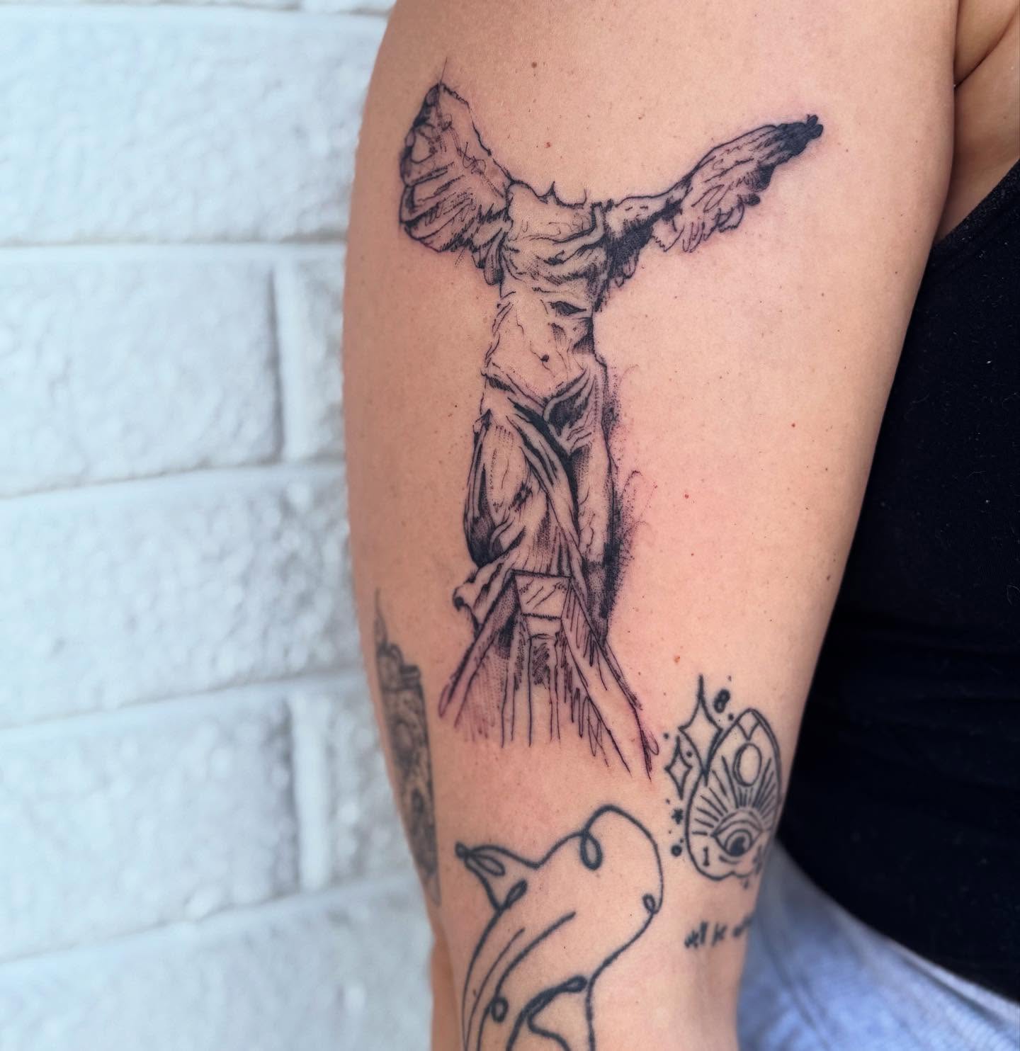 Statue of liberty black and grey tattoo on the forearm by Cohen