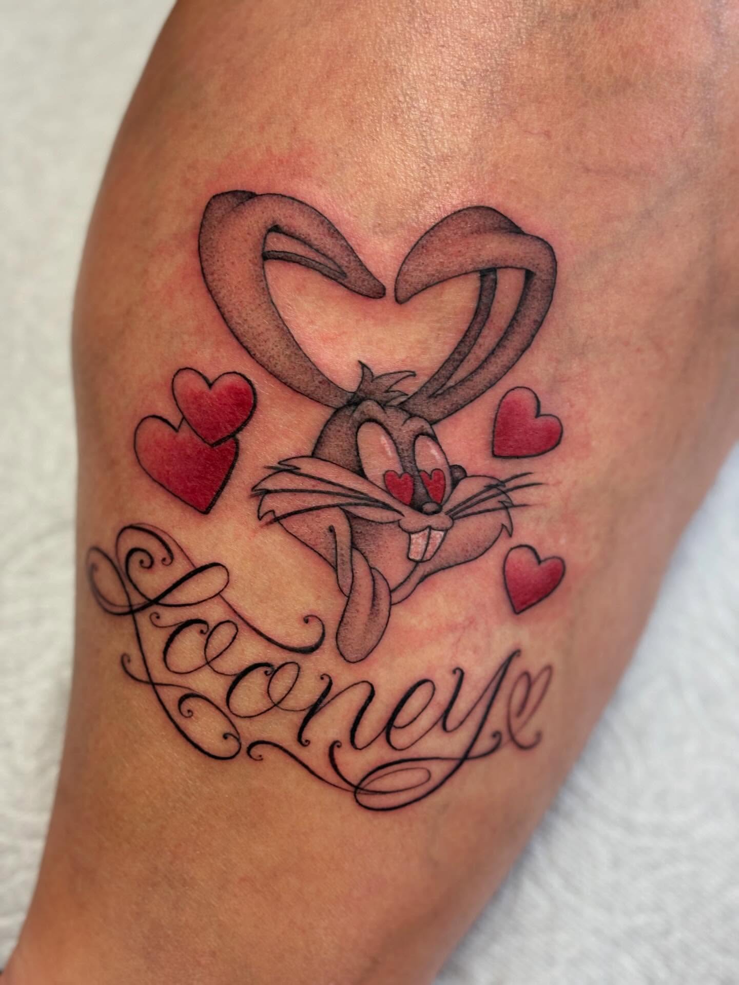 Looney Tunes character black and grey tattoo on the thigh by Storm