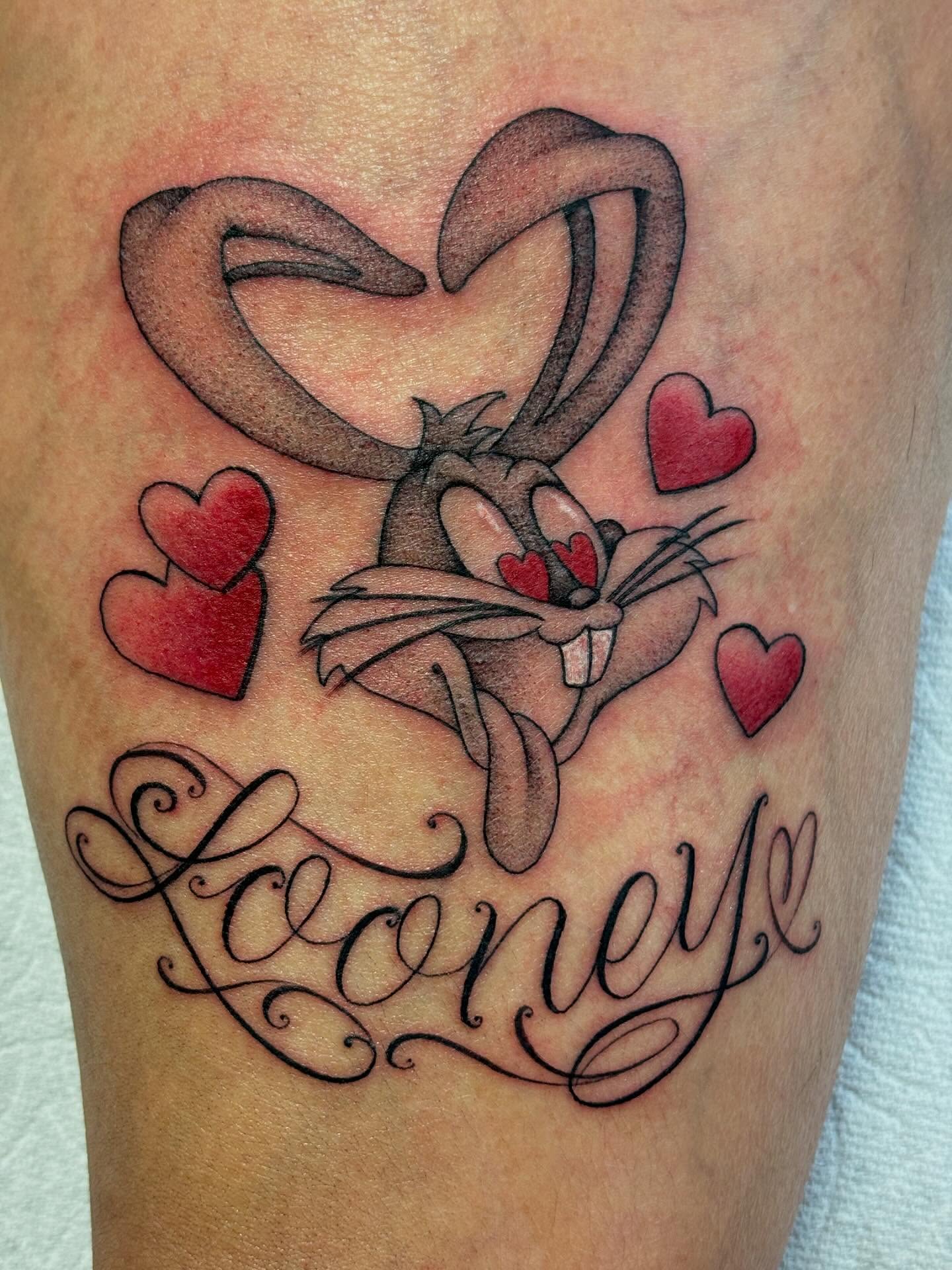 Looney tunes character black and grey tattoo on the thigh by Storm