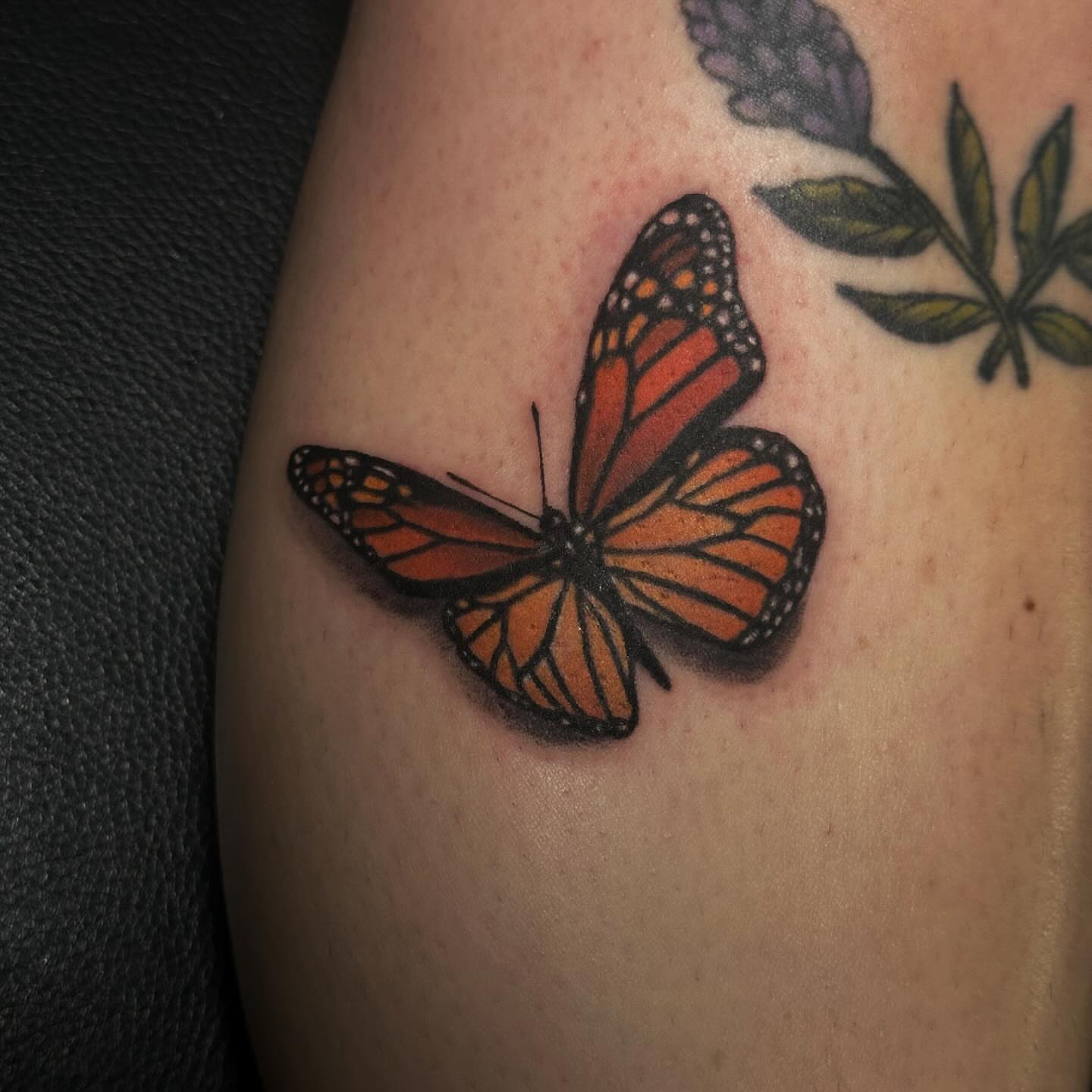 Monarch butterfly realism tattoo on the upper arm by Elizabeth Tabler
