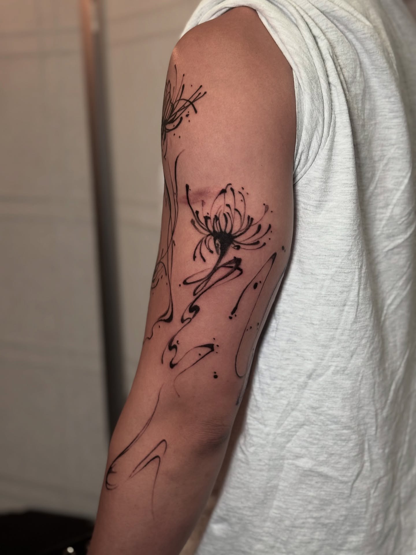 Floral design black and grey tattoo on the forearm by Kbtattz