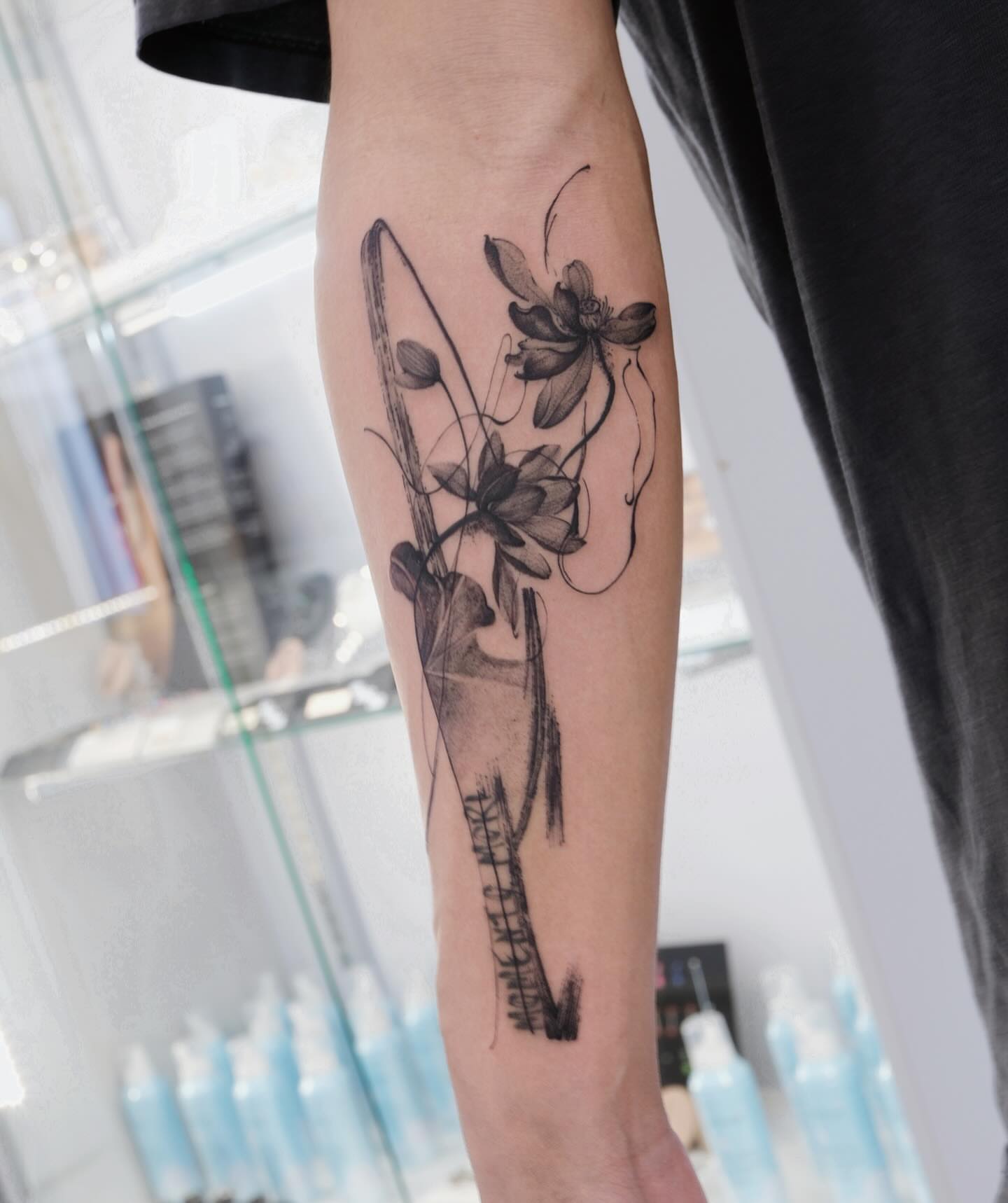 Lotus flowers minimalist tattoo on the forearm by MJ tattooist