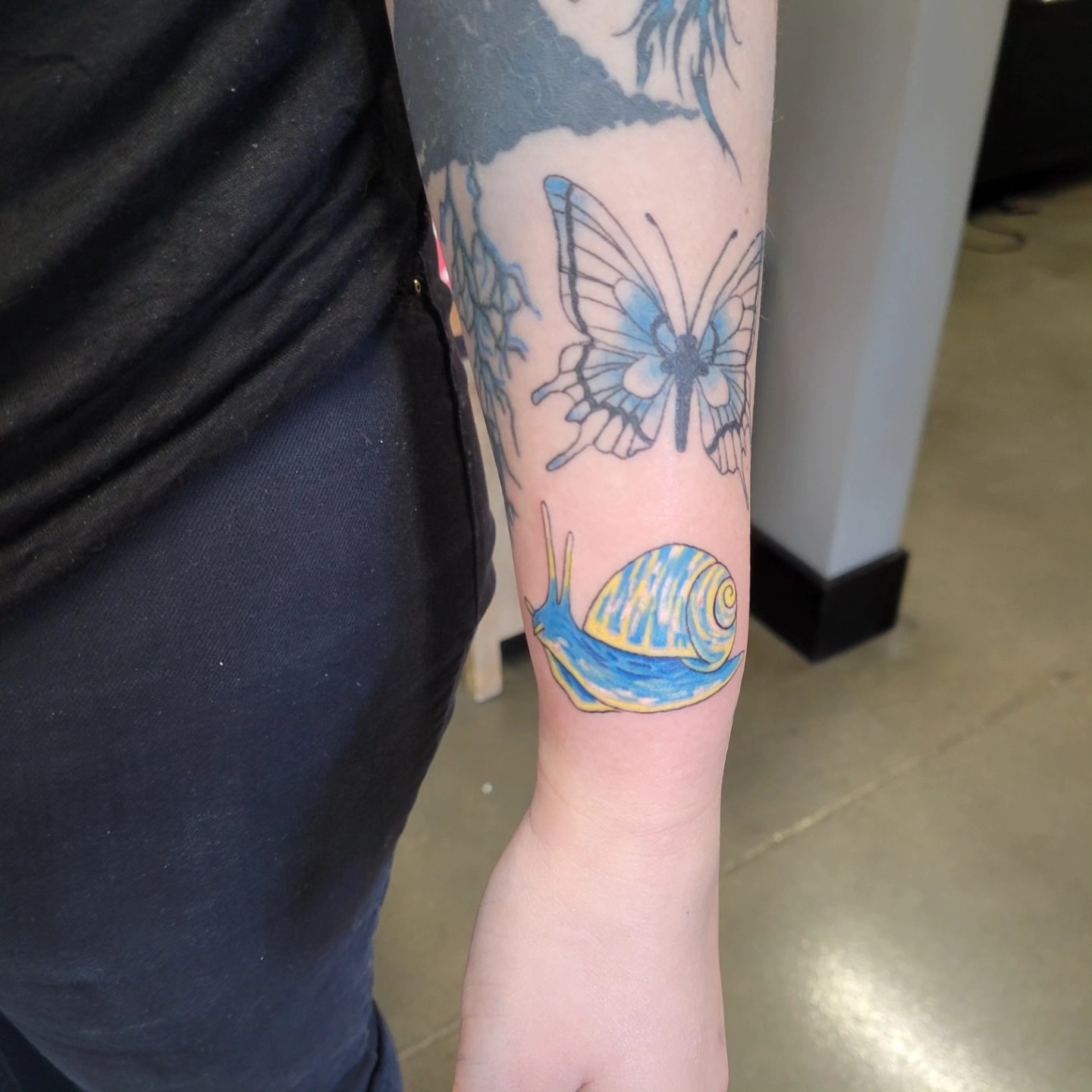 Snail shell new school tattoo on the forearm by Aspen C