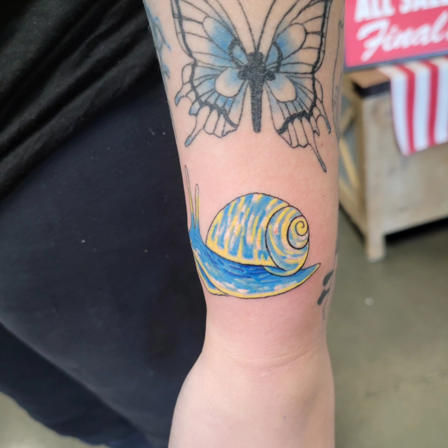 Butterfly and shell new school tattoo on the forearm by Aspen C