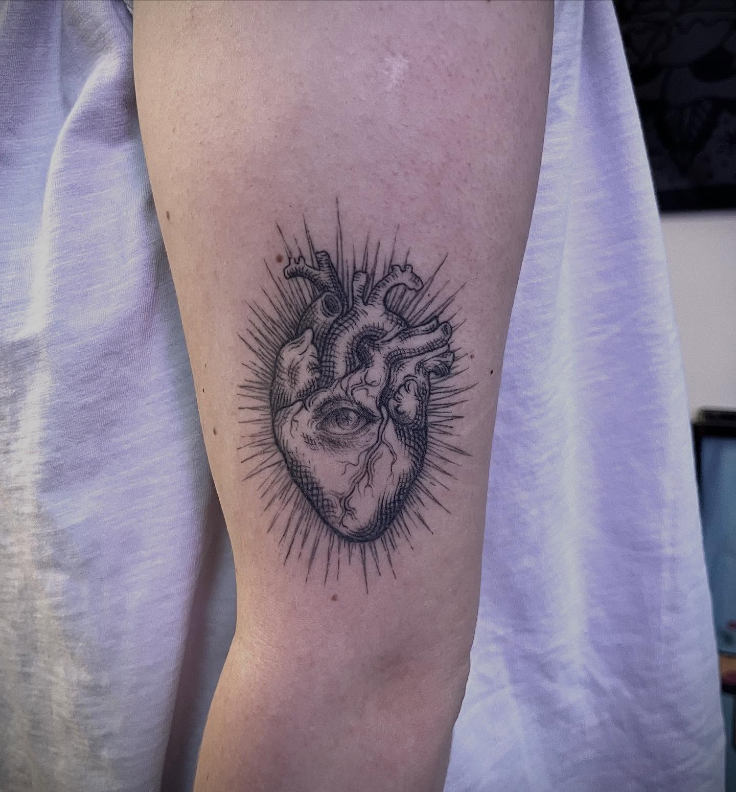 Heart black and grey tattoo on the forearm by Tattoo Artist