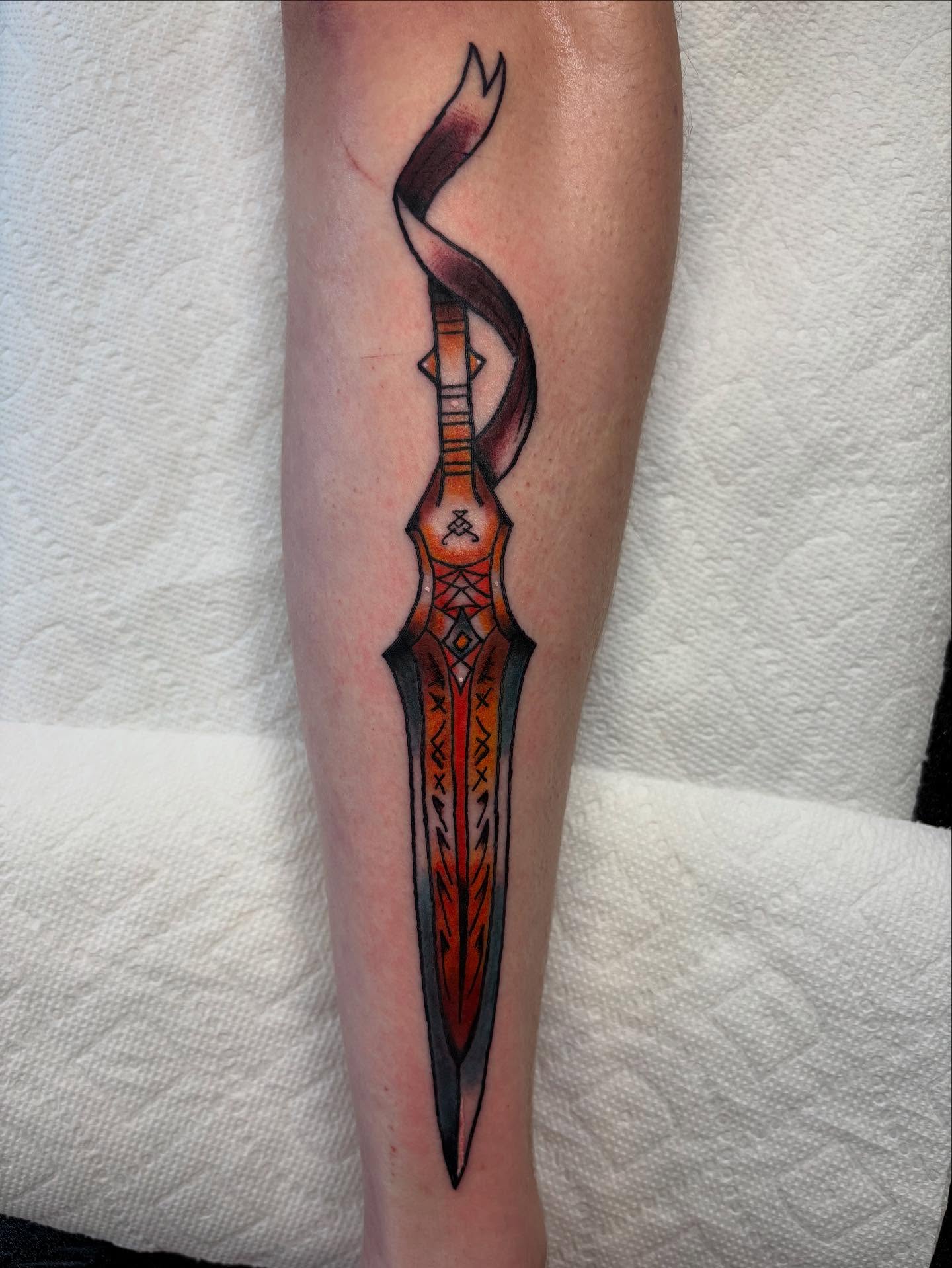 Dagger geometric tattoo on the forearm by Ben Whyte